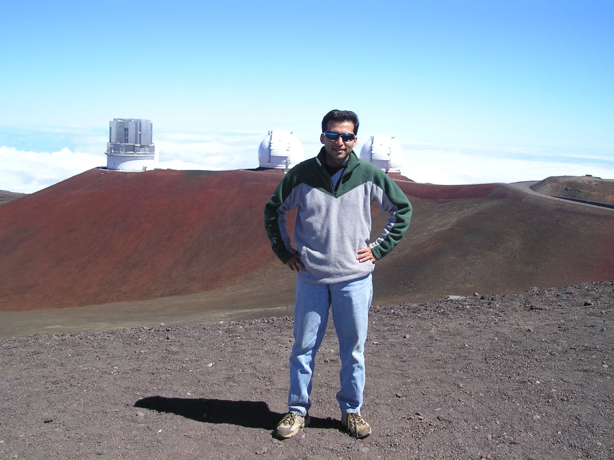 June 2005: In front of the twin Keck Observatories and Subaru Observatory on top of Mauna Kea, Hawaii. Salman was using the James Clark Maxwell Telescope (JCMT) on the summit.
