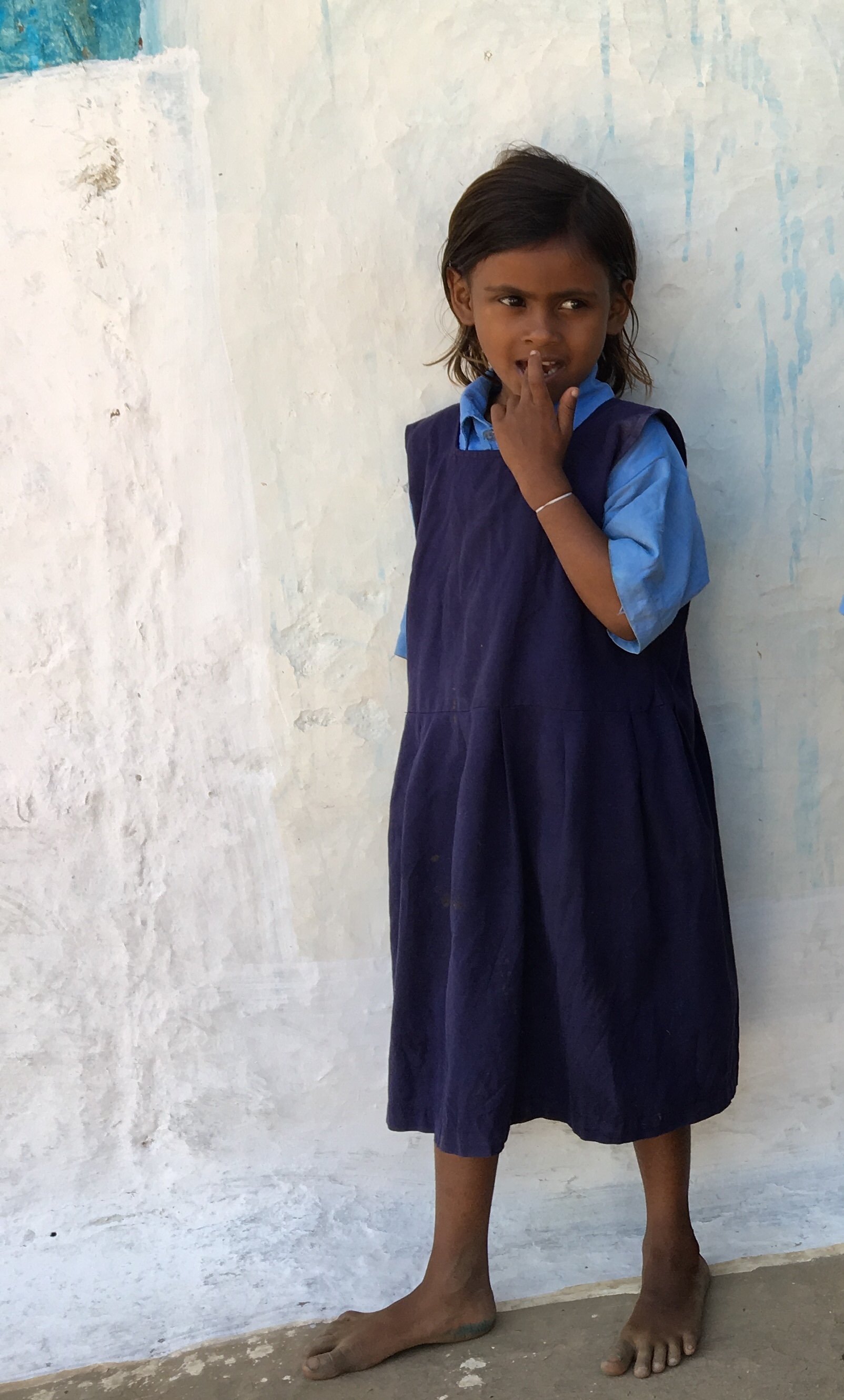 Little girl blue dress white wall Bhorameo.jpg