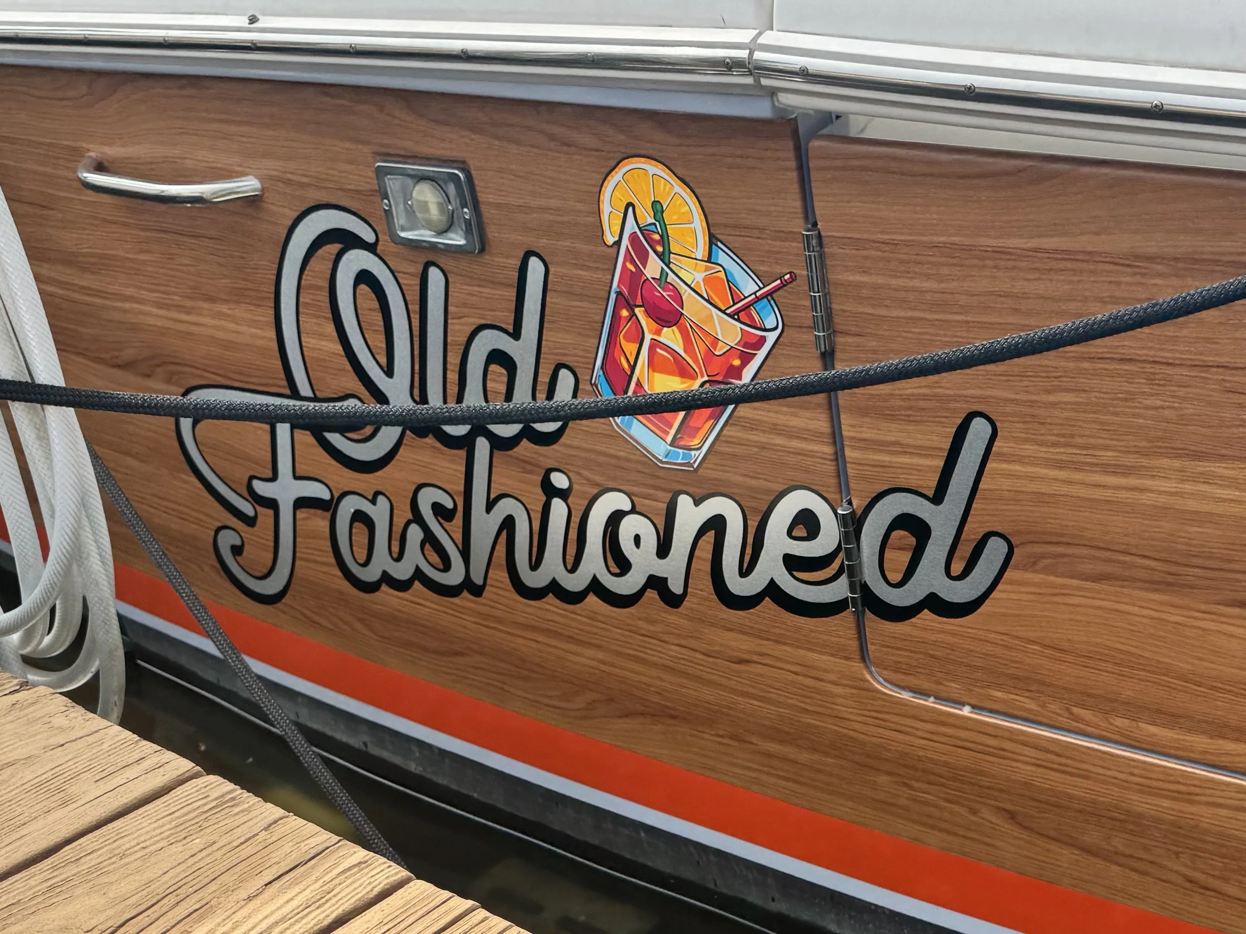 Faux wood grain vinyl wrap with 22k silver leaf name graphics