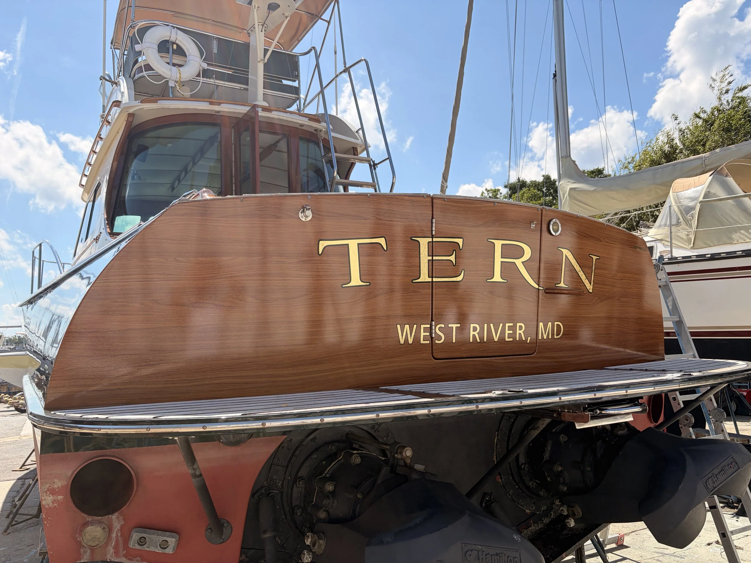 Faux wood grain transom wrap with 22k Florentine gold leaf name