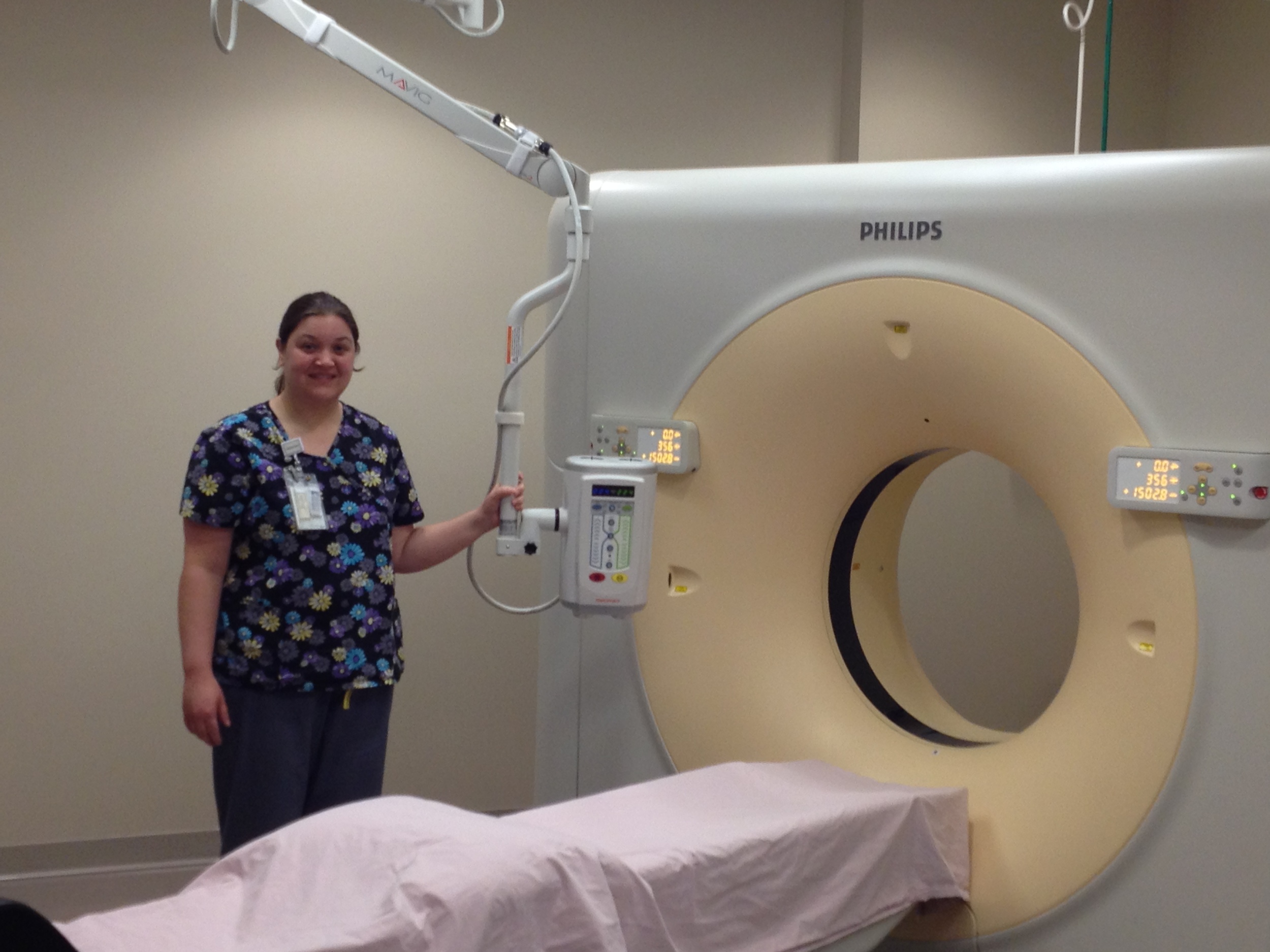 Pictured: Nicole Morris, the medical center's lead radiology technician demonstrates some of the features of South Central Kansas Medical Center's 64-slice CT machine.
