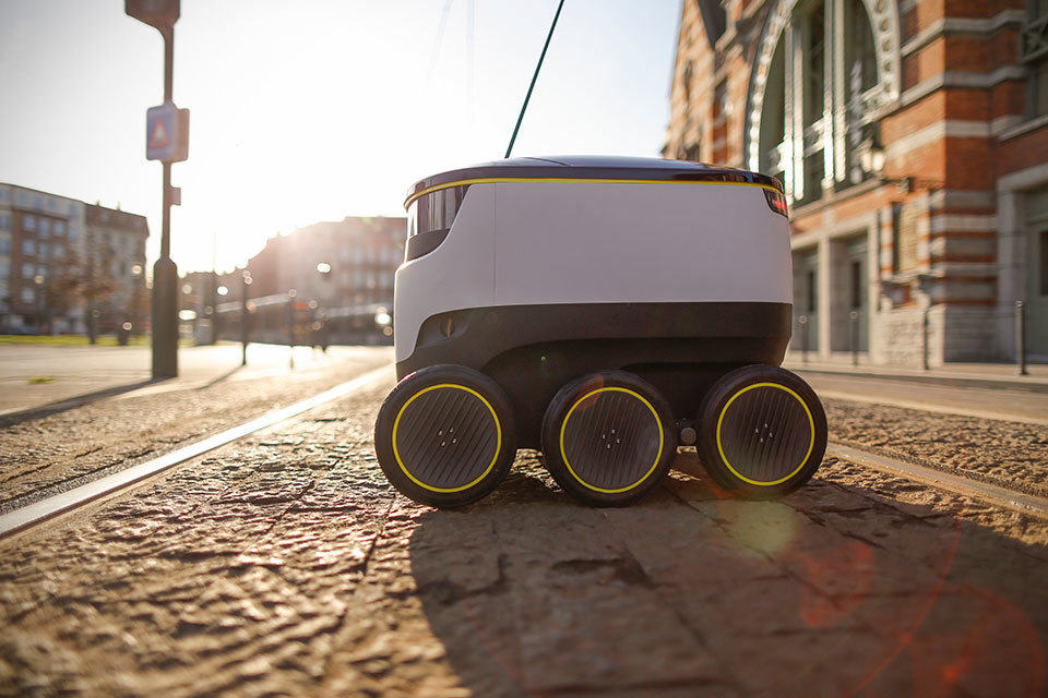 Starship technologies delivery robot. Can hold up to 2 bags of shopping and has a range of 3 miles. Autonomously pilots its way along the sidewalk to deliver to homes.