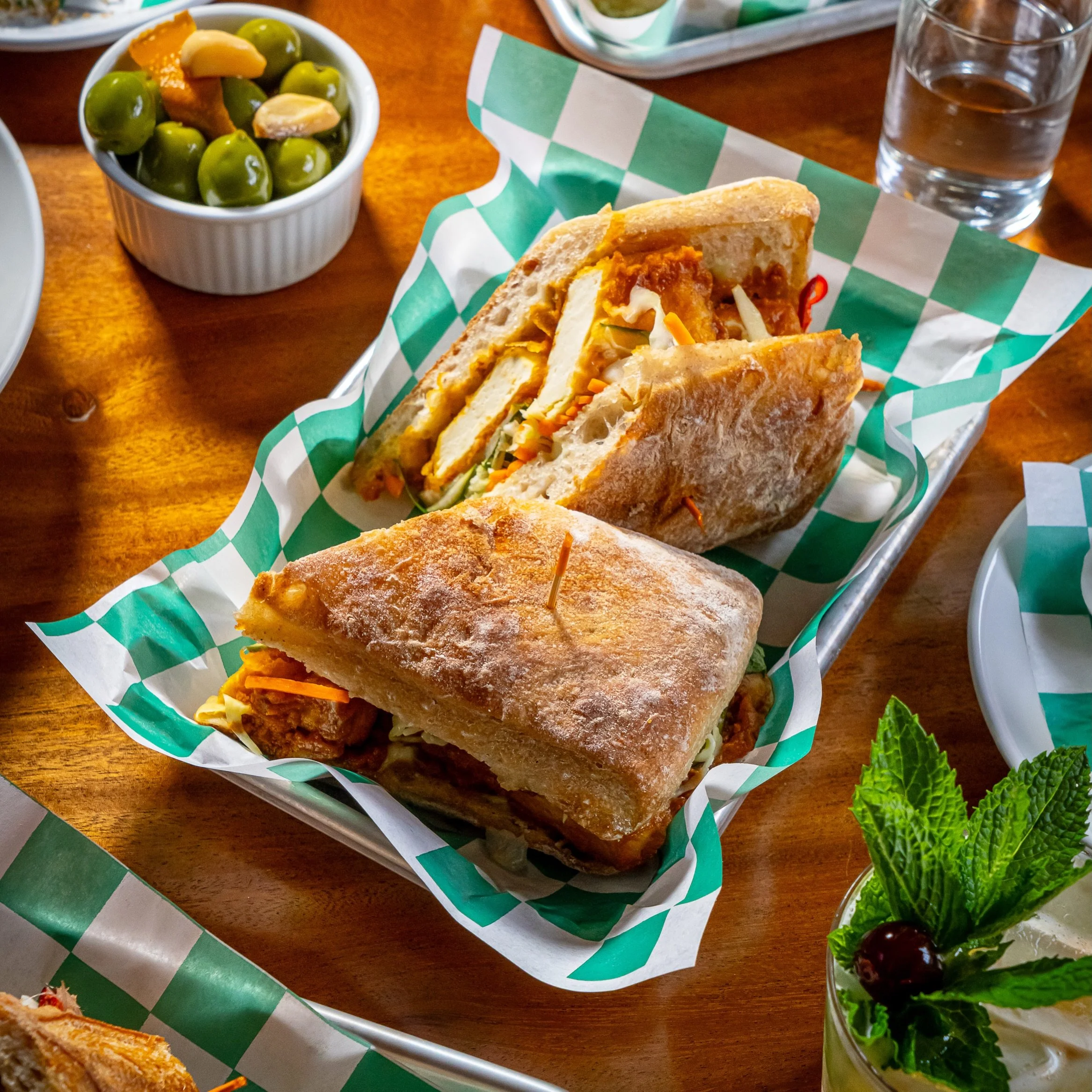 It&rsquo;s Thursday &amp; that means @babydudes is back in the kitchen! Today&rsquo;s pick is the STICKY TOFU SANDWICH. Lightly fried slabs of tofu bathed in a special peanut bbq sauce w/ pickled fresno chile, marinated cucumbers, carrot-cabbage slaw