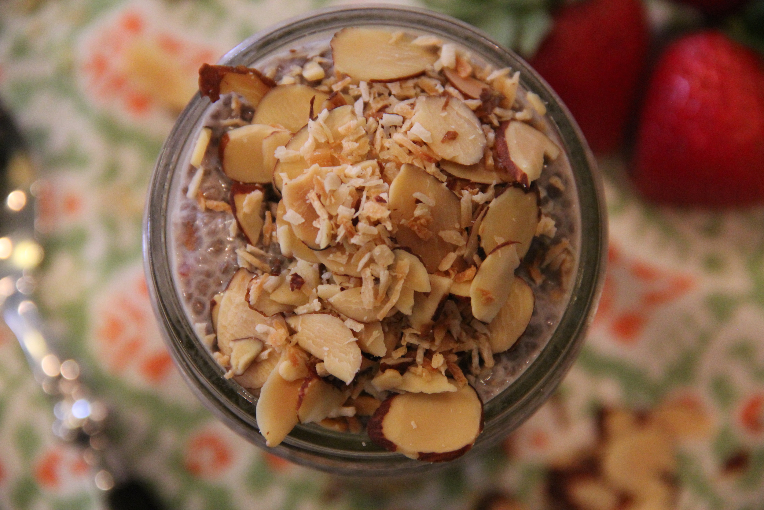 Carly's Wellness Kitchen Strawberry chia seed pudding with toasted coconut and slivered almonds