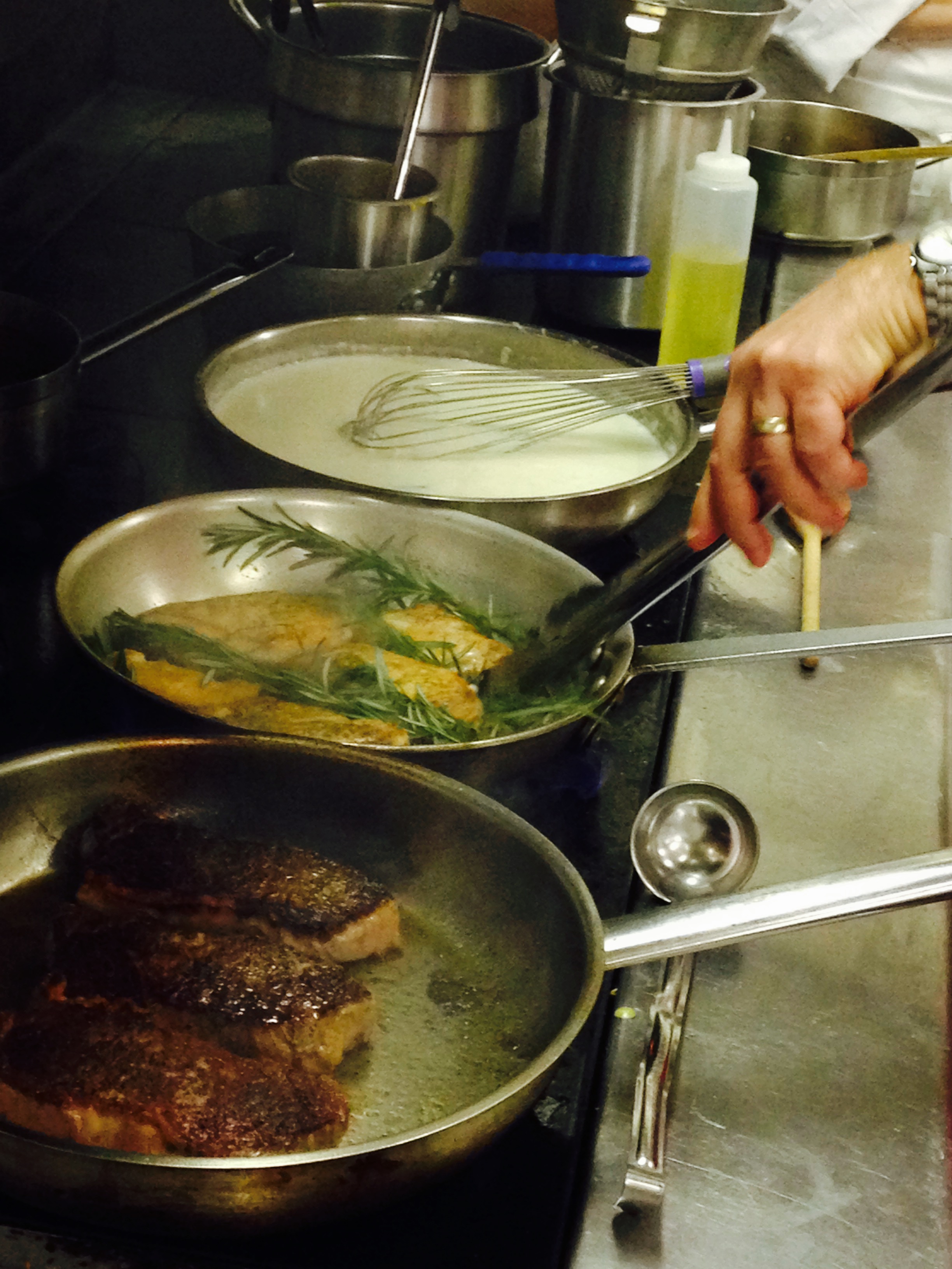 Chef Fournier demonstrated what it's like to cook on the line—managing several hot pans and bubbling stocks at once.