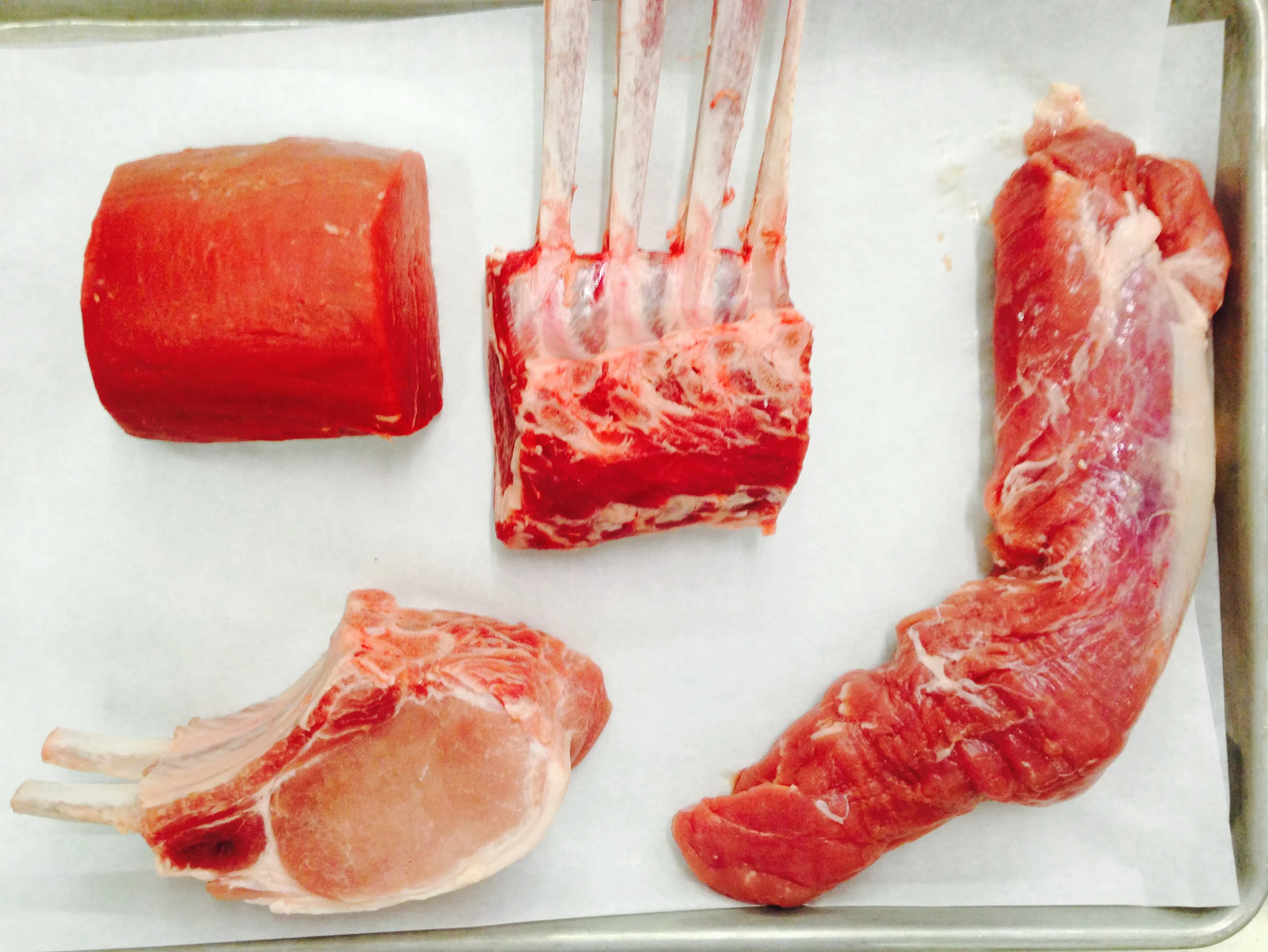 Clockwise from top left: beef tenderloin, rack of lamb, pork tenderloin, double-cut pork chop