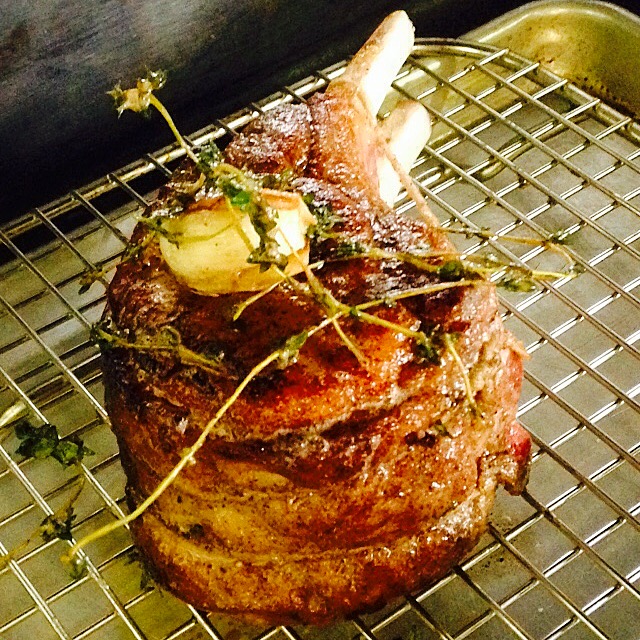 A close-up of my double-cut pork chop seasoned with garlic and thyme.