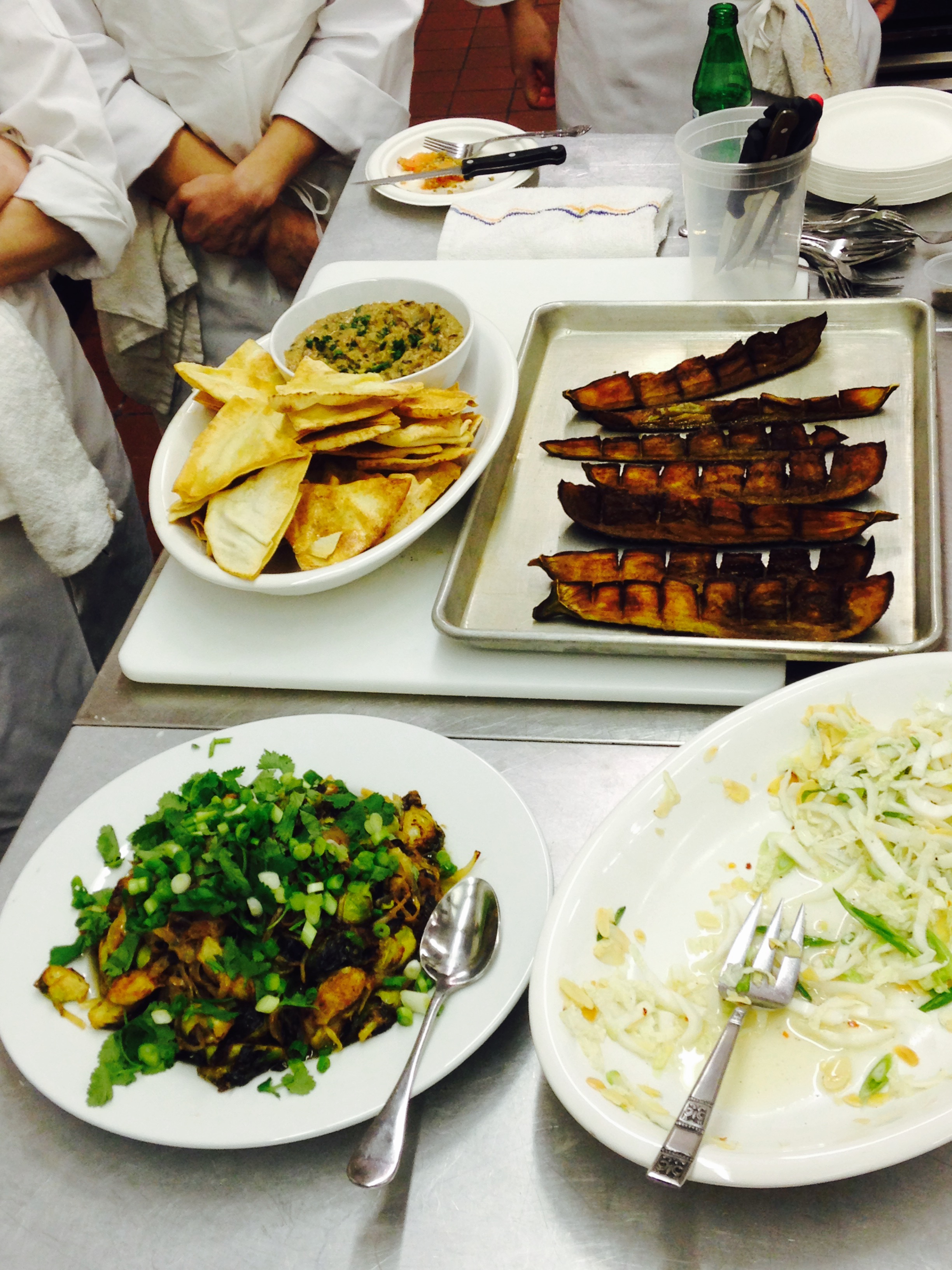 Babaganoush with pita chips, fried miso brussels sprouts topped with scallions and cilantro, and eggplant chicherones.