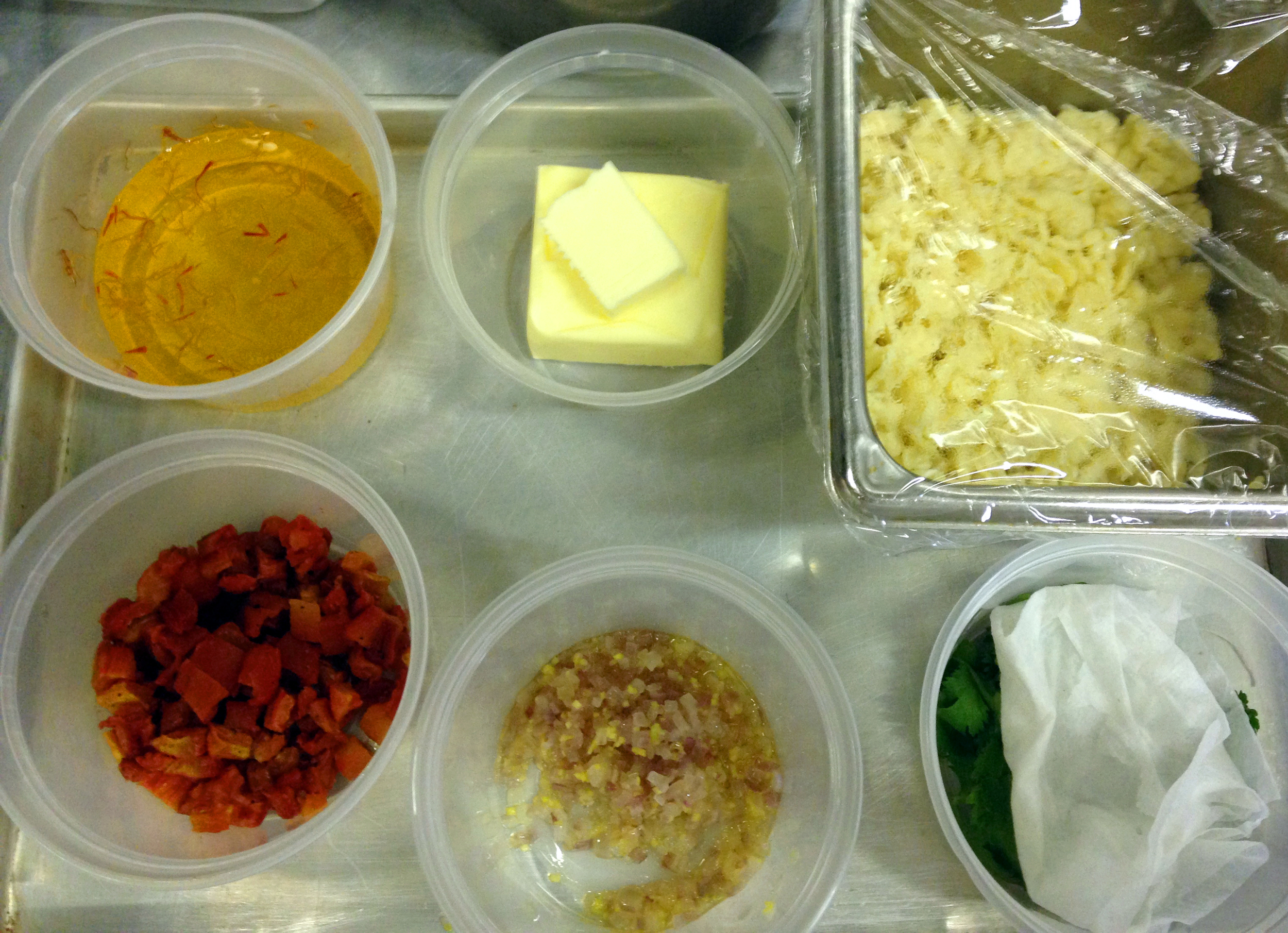 Mise en place for my mussel dish—saffron infused white wine, butter, spaetzle cilantro, sweated shallots and ginger, tomato confit