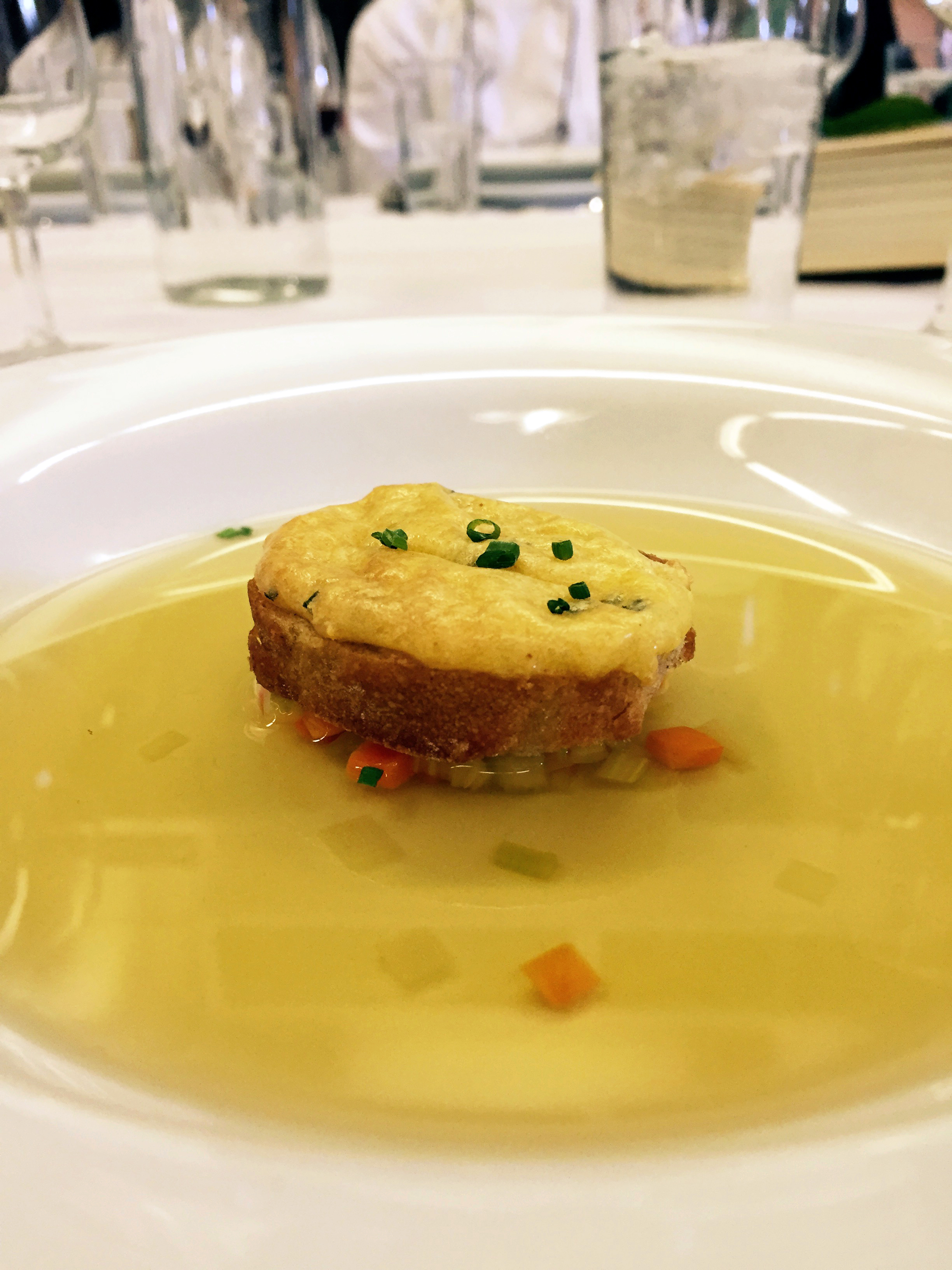 Second course, le consommé double de volaille aux diablotin et brunoise - chicken consomme with finely chopped vegetables and cheezy crouton 