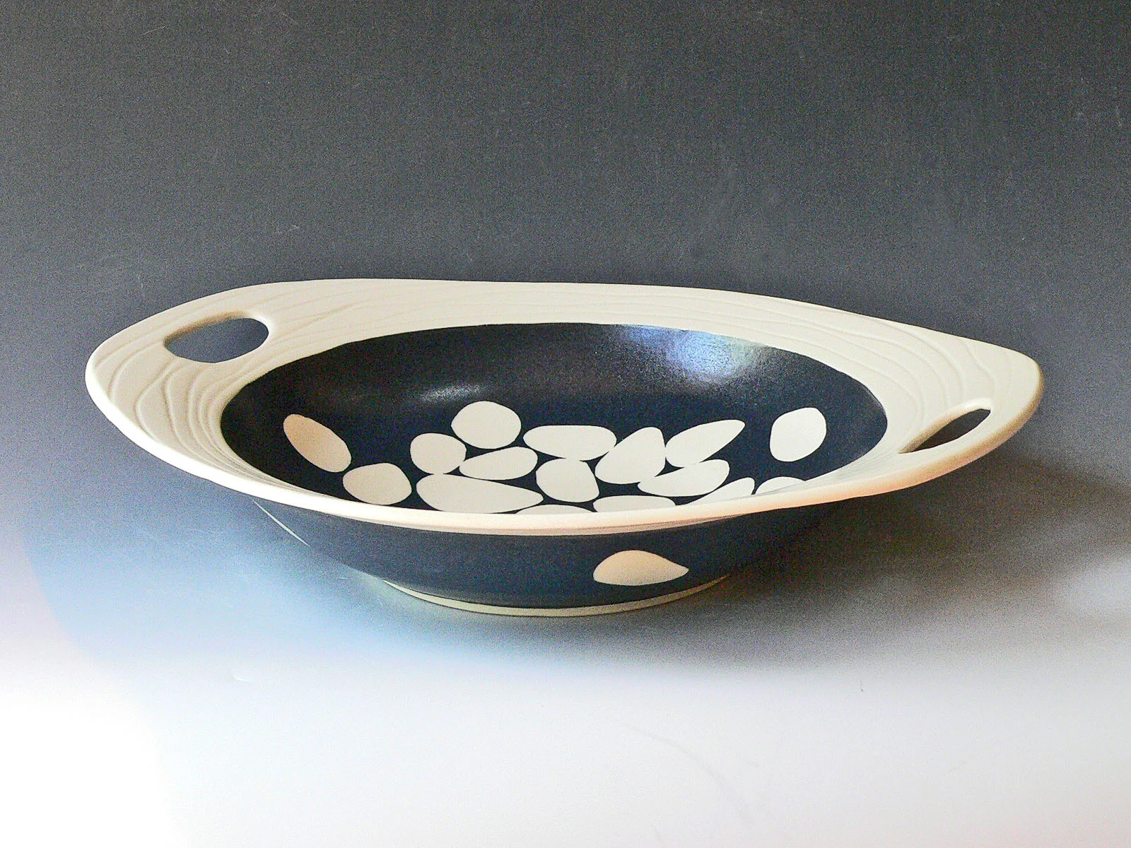 Handled low rimmed serving bowl - stones