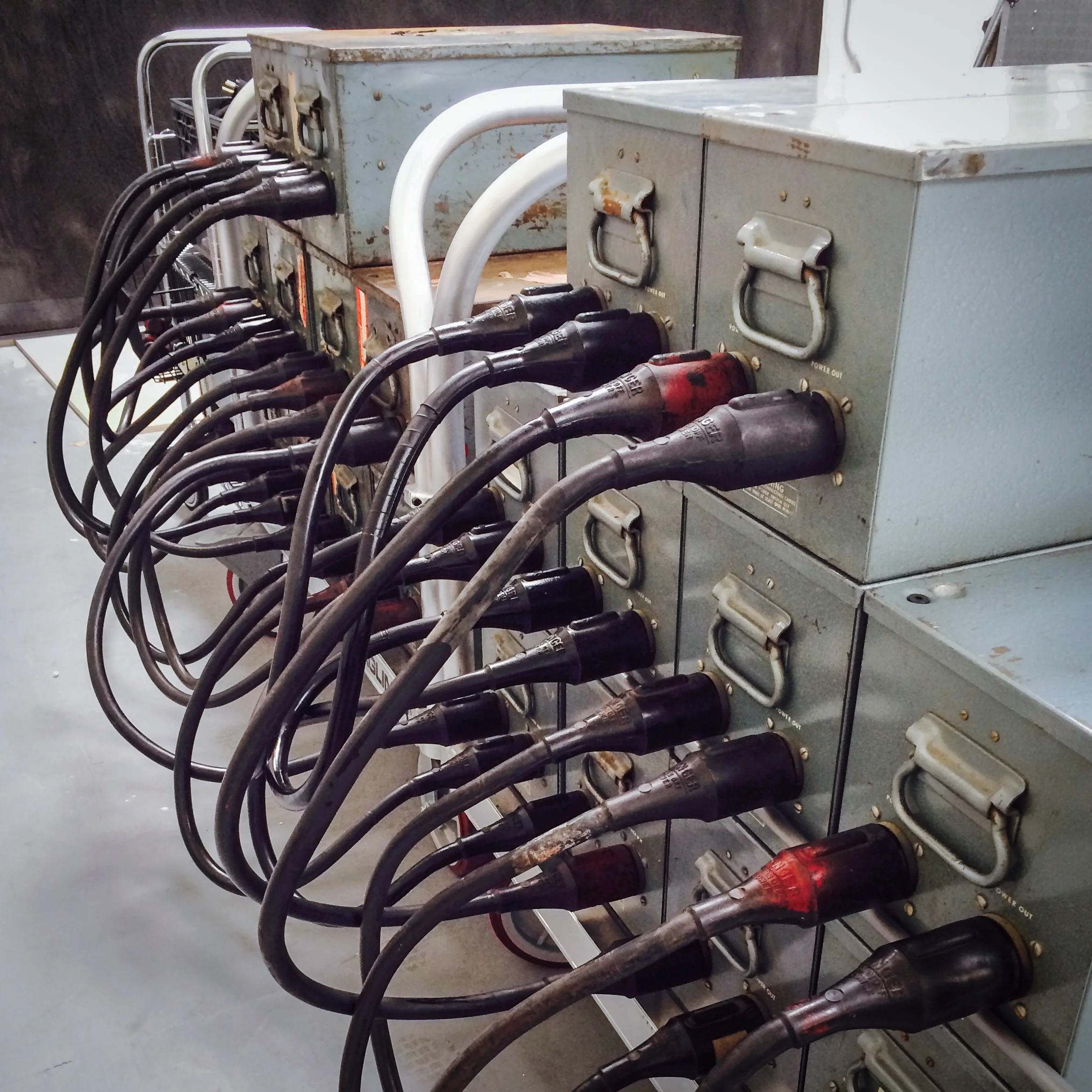 Two carts holding 20 Ascor Condensers (capacitors), equivalent to 16,000 watt-seconds of potential strobe power. Each Condenser weighs in at 65 lbs. each.