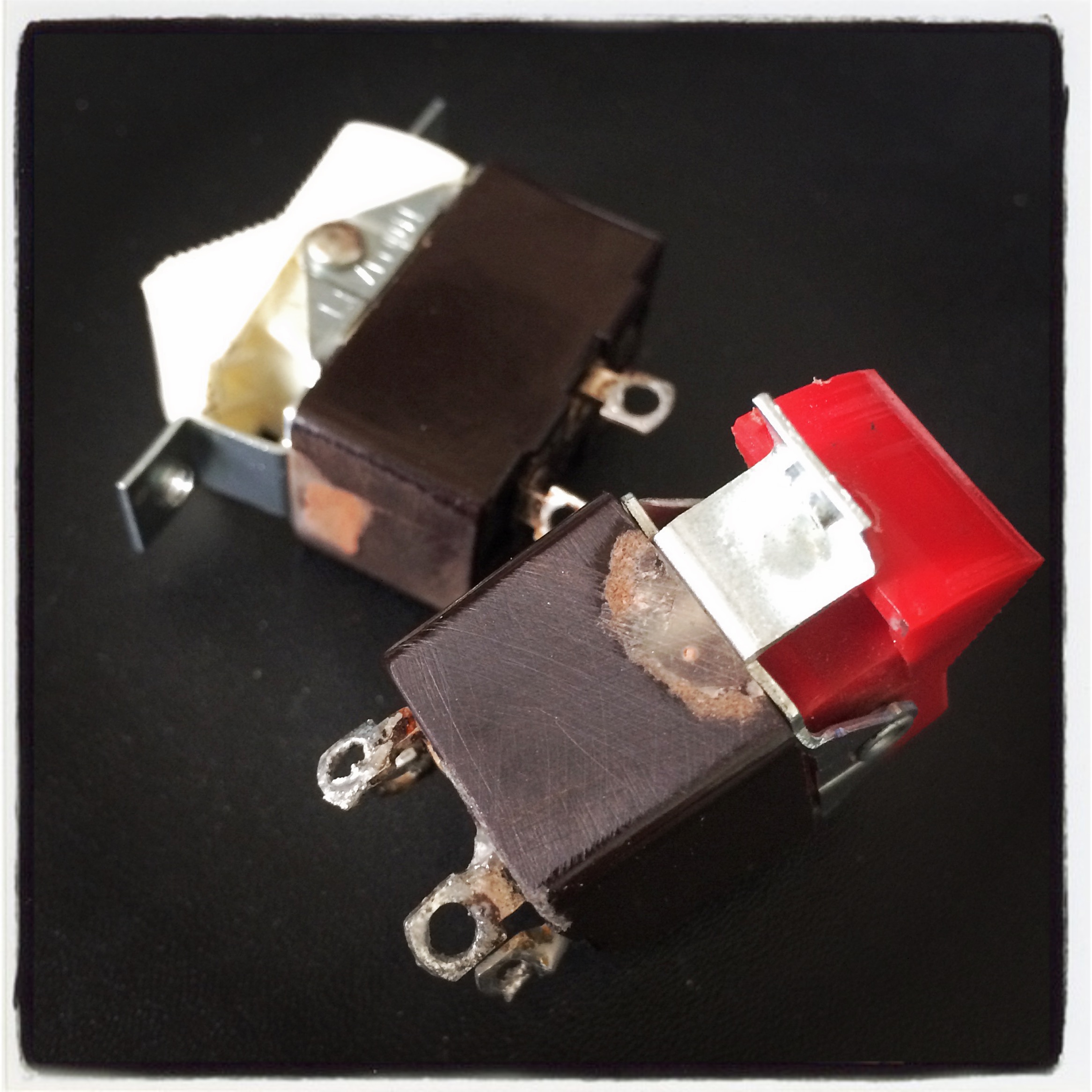 Rocker switches repaired with epoxy and machine screws, replacing broken Bakelite and rivets.