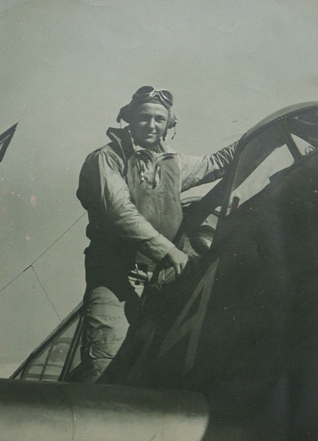 Portrait of Ken Glass standing on his TBM-3 Avenger.