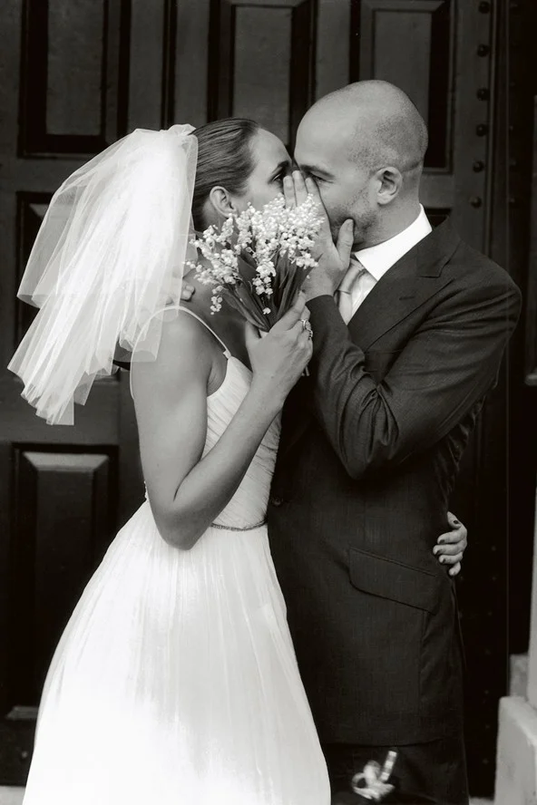 Rosemary Ferguson and Jake Chapman hiding a kiss, Vogue, 2004