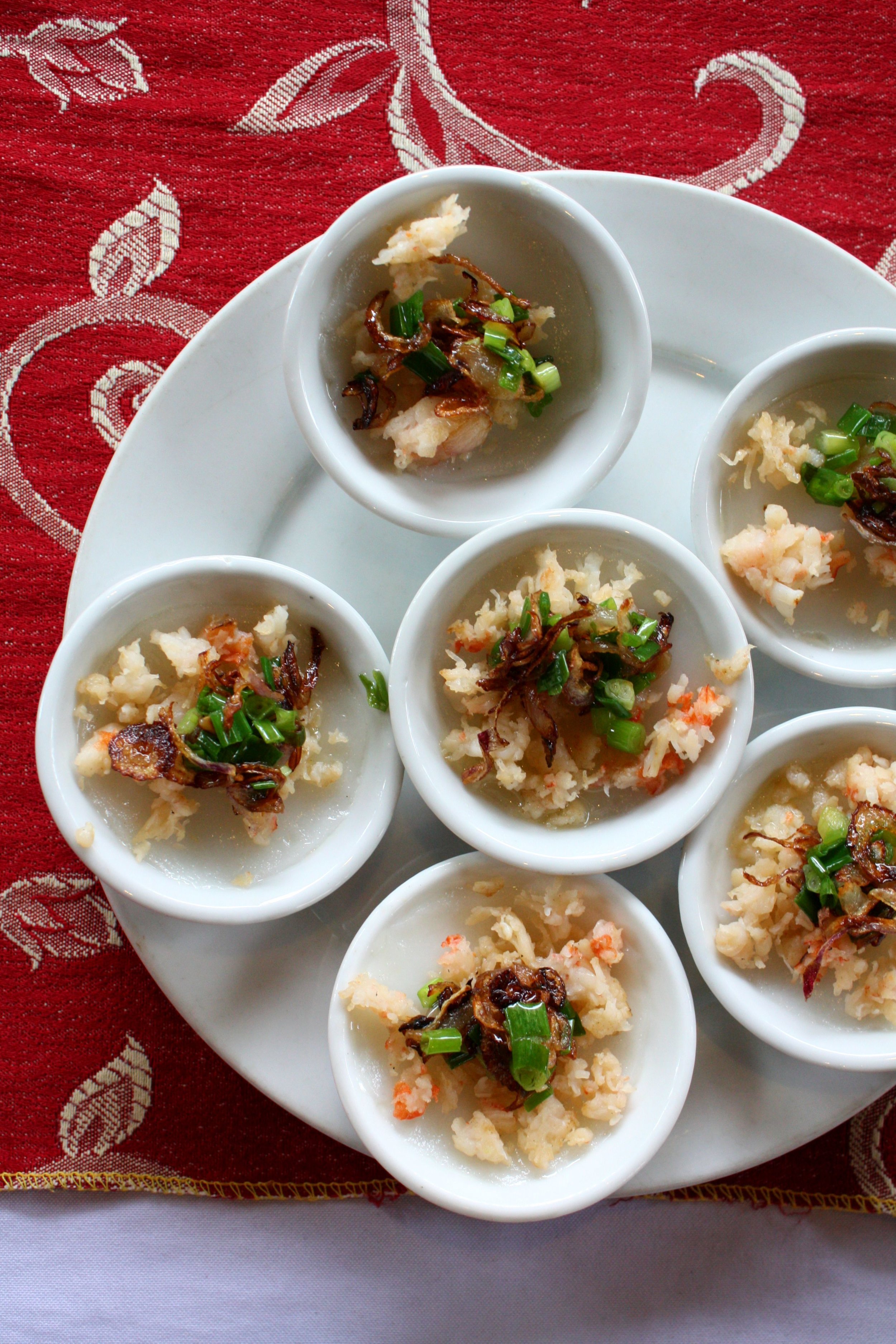  Freshly steamed Banh Beo (steamed rice flour "pancakes") topped with sautéed shrimp, crispy shallots and green onions. 