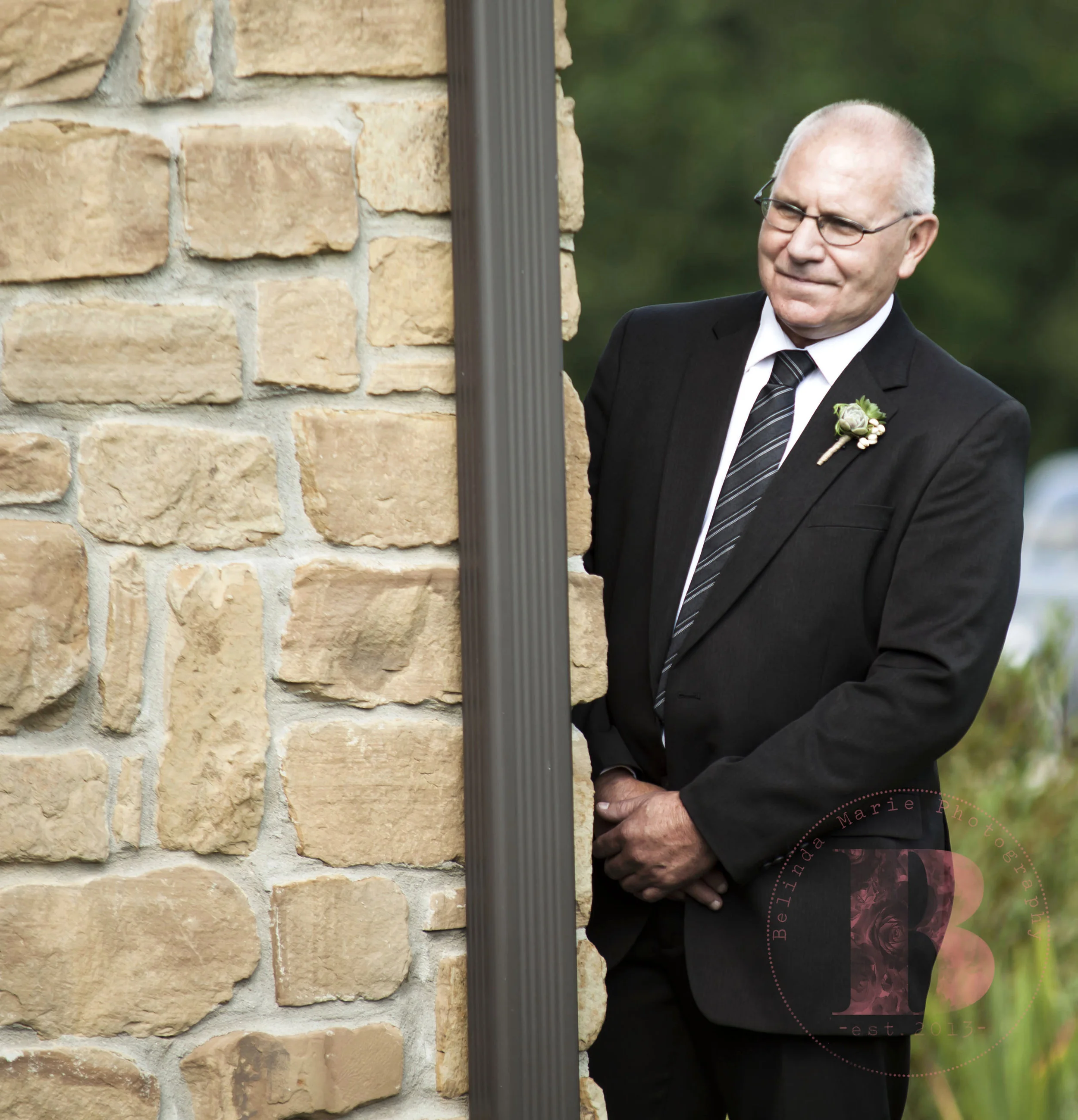 Father of the bride sneaking a peek prior to walking down the aisle