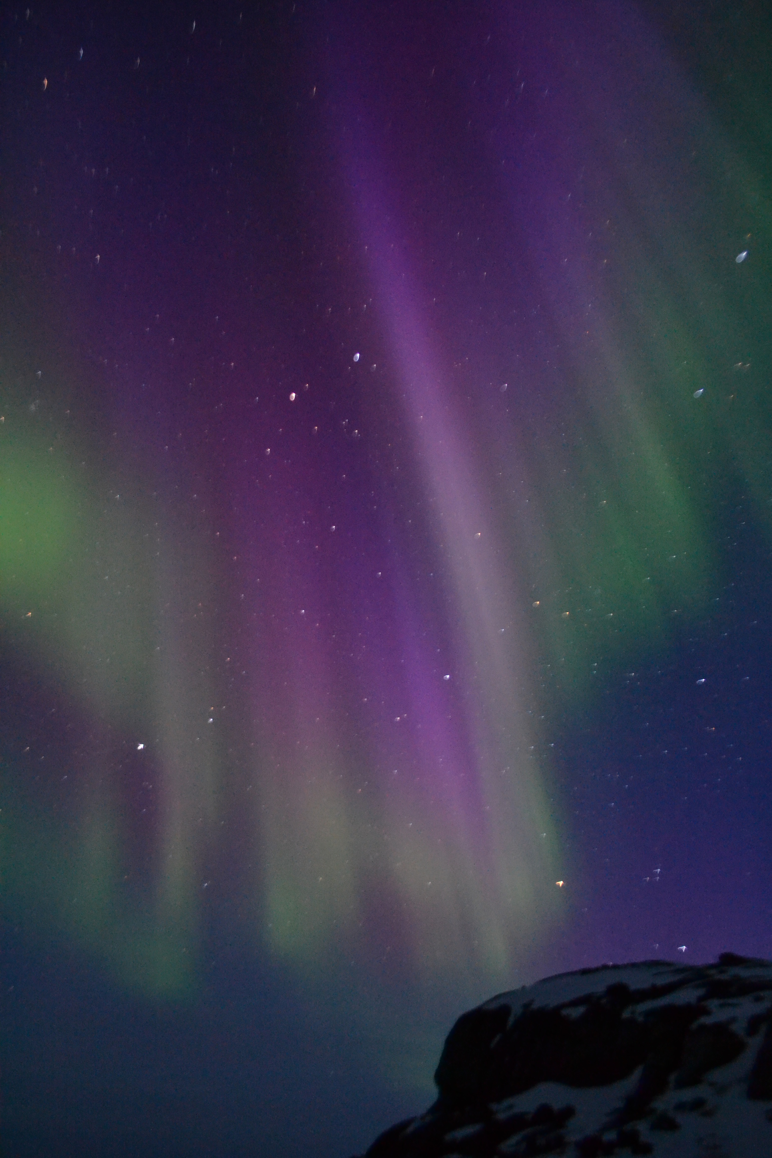 An aurora is seen over Greenland on April 2, 2011. Two NASA sounding rockets will launch into a particular type of aurora called a cusp aurora this winter to study different processes related to the particle acceleration that causes cusp auroras. The cusp is a region near the North Pole where Earth’s magnetic field is directly connected to the solar wind, allowing daytime auroras to form. - Image credit: NASA/University of Maryland, College Park/Robert Michell