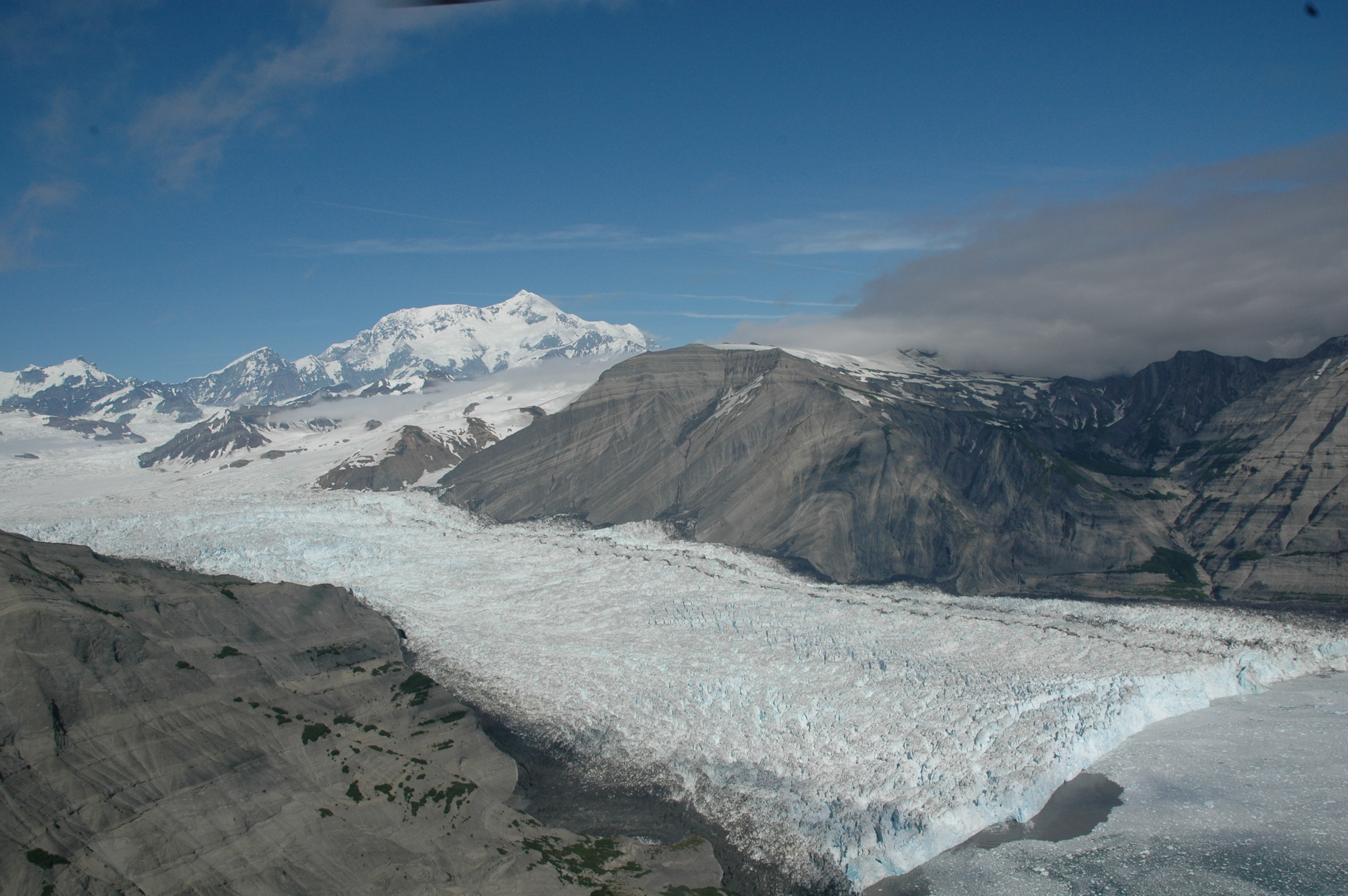 The tidewater Yahtse Glacier in Icy Bay, Alaska eroding uplifted young marine sedimentary rock of the Yakataga Formation that are equiavelnt to those drilled in IODP Expedition 341. - Image Credit: Ken Ridgway, Purdue Univeristy