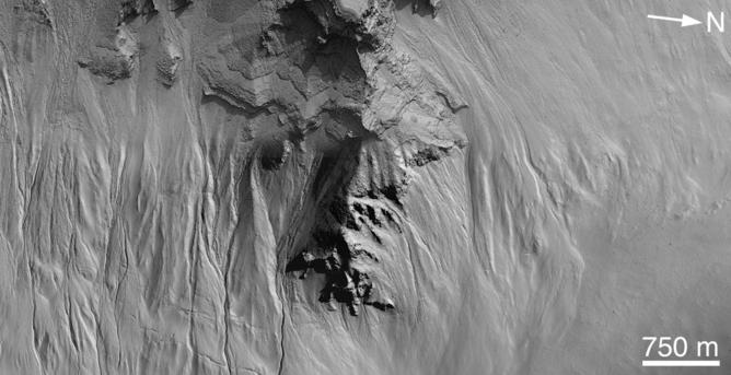 Gullies inside a Martian crater. – Image Credit: NASA