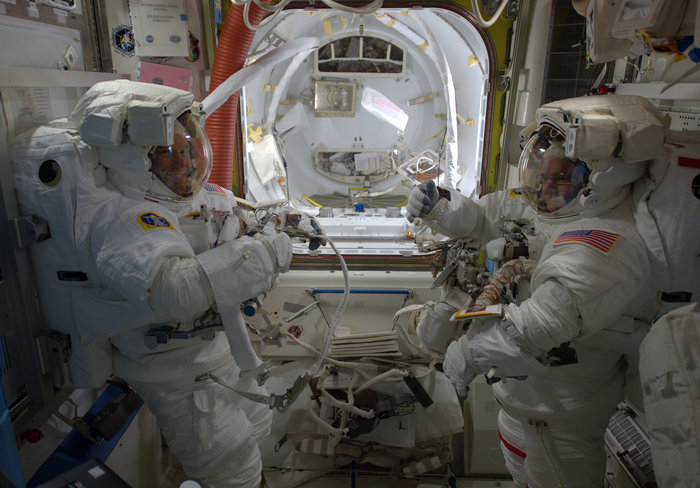 NASA astronauts Scott Kelly and Tim Kopra prepare for a spacewalk, December 2015. - Image Credit: ESA/NASA
