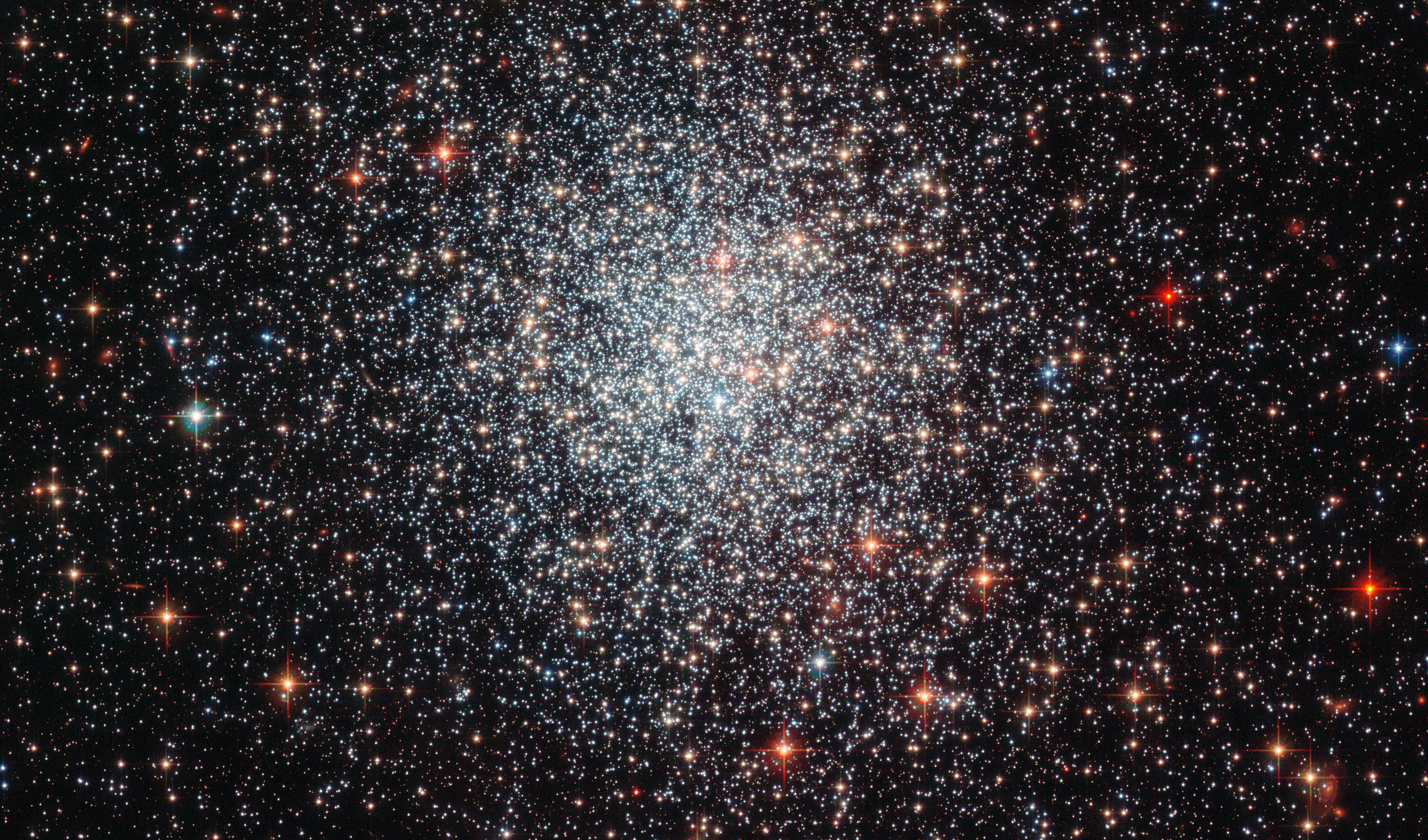 A portrait of the massive globular cluster NGC 1783 in the Large Magellanic Cloud, taken by the Hubble Space Telescope. This dense swarm of stars is located about 160,000 light years from Earth and has the mass of about 170,000 Suns. A new study by astronomers from the Kavli Institute for Astronomy and Astrophysics at Peking University (KIAA), the National Astronomical Observatories of the Chinese Academy of Sciences (NAOC), Northwestern University and the Adler Planetarium suggests the globular cluster swept up stray gas and dust from outside the cluster to give birth to three different generations of stars. - Image Credit: ESA/Hubble and NASA,. Acknowledgement: Judy Schmidt (geckzilla.com)