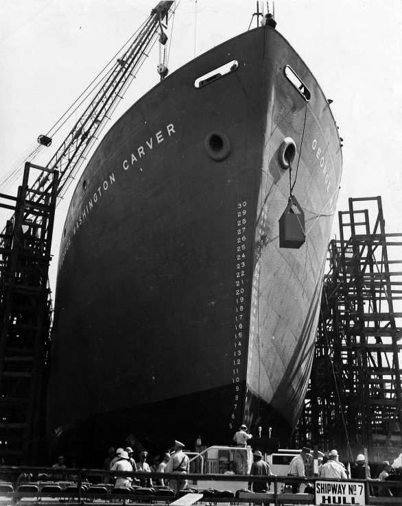 A Liberty ship, SS George Washington Carver, launches in 1943. By 1944, wartime production of these "ugly duckling" cargo steamers took an average of 42 days. - Image Credits: E.F. Joseph/The New York Public Library/Photographs and Prints Division