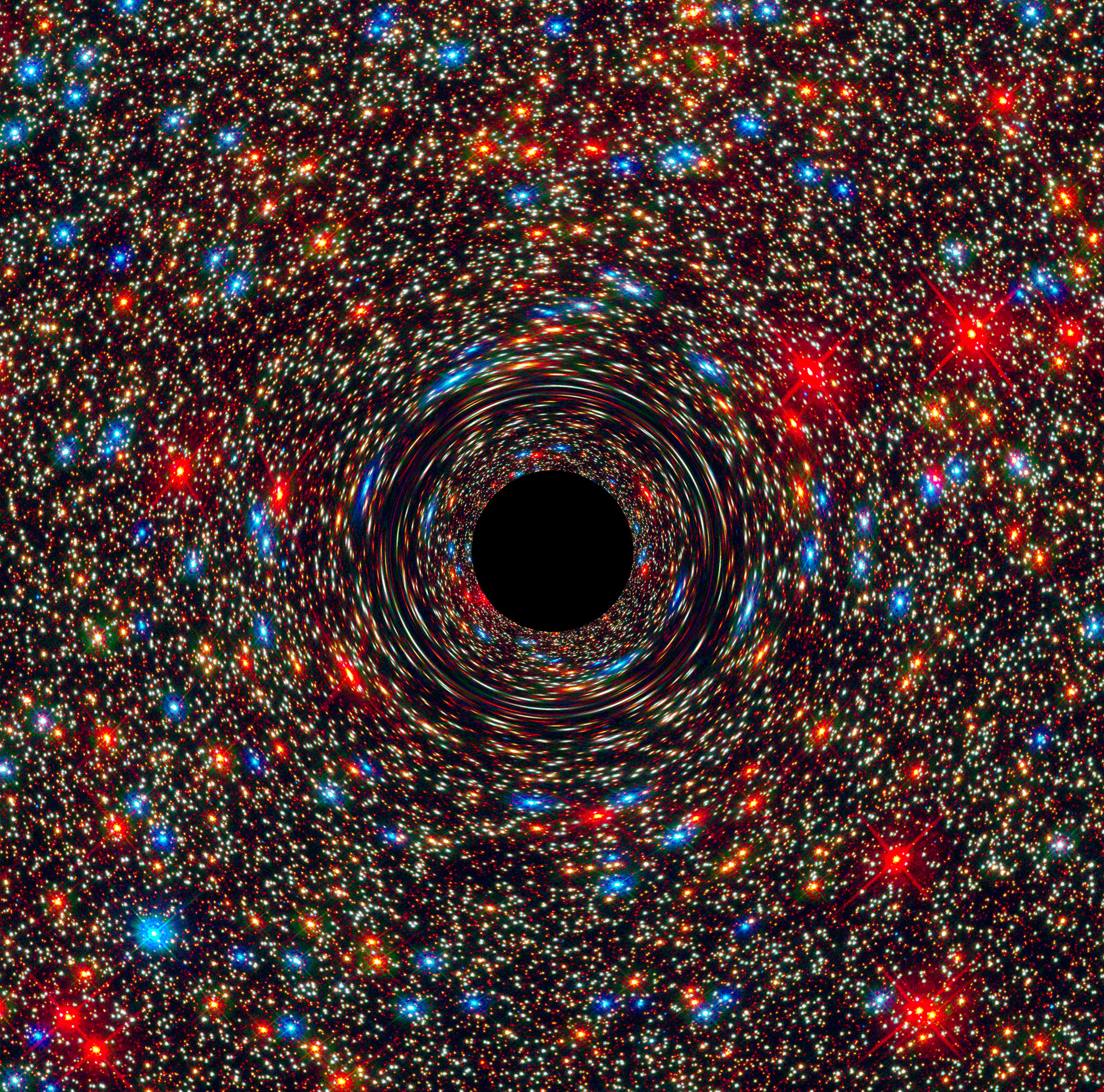 This computer-simulated image shows a supermassive black hole at the core of a galaxy. The black region in the center represents the black hole’s event horizon, where no light can escape the massive object’s gravitational grip. The black hole’s powerful gravity distorts space around it like a funhouse mirror. Light from background stars is stretched and smeared as the stars skim by the black hole - Image Credits: NASA, ESA, and D. Coe, J. Anderson, and R. van der Marel (STScI)