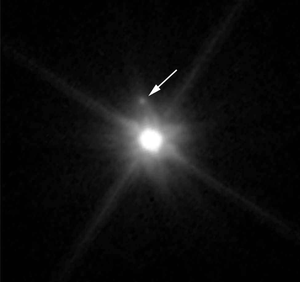 This Hubble image reveals the first moon ever discovered around the dwarf planet Makemake. The tiny satellite, located just above Makemake in this image, is barely visible because it is almost lost in the glare of the very bright dwarf planet. Hubble’s sharp-eyed WFC3 made the observation in April 2015. - Image Credits: NASA, ESA, and A. Parker and M. Buie (SwRI)