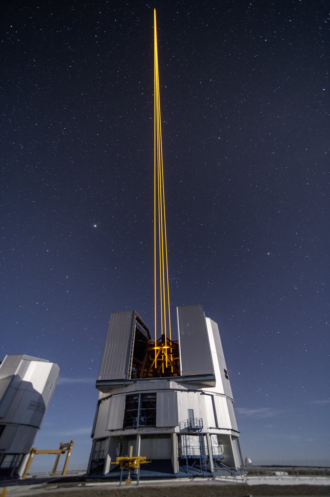 This spectacular image shows the four beams emerging from the new laser system on Unit Telescope 4 of the VLT. – Image Credit: ESO/F. Kamphues