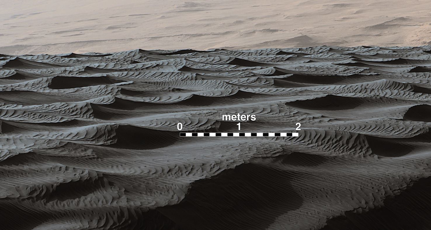 Two sizes of ripples are evident in this Dec. 13, 2015, view of a top of a Martian sand dune, from NASA's Curiosity Mars rover. Sand dunes and the smaller type of ripples also exist on Earth. The larger ripples are a type not seen on Earth nor previously recognized as a distinct type on Mars. – Image Credits: NASA/JPL-Caltech/MSSS
