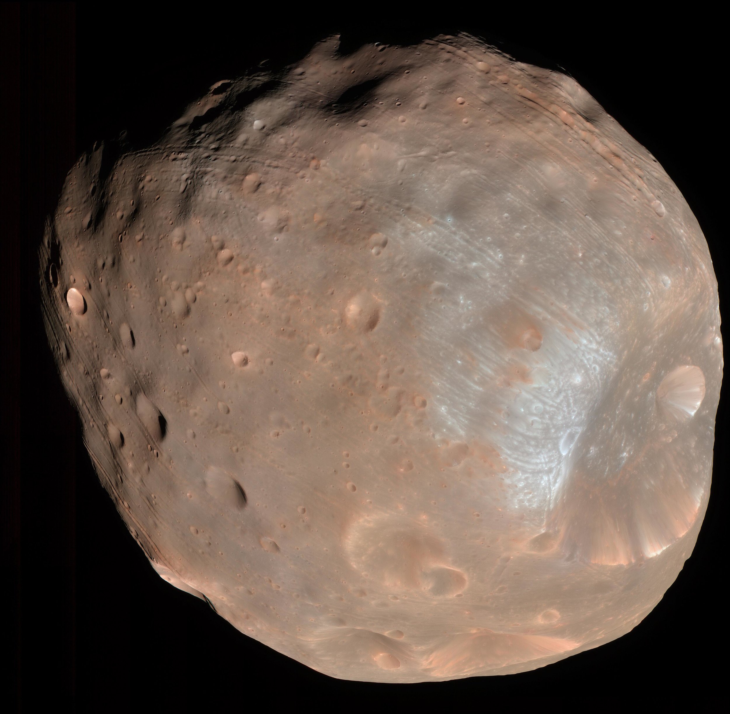 Mars moon Phobos sports linear grooves and crater chains whose origin has never explained. - Image Credit: NASA/JPL