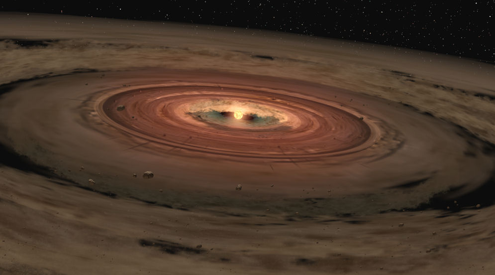 Planets coalescing out of the remaining molecular cloud the star formed out of. Within this accretion disk lay the fundamental elements necessary for planet formation and potential life. Credit: NASA/JPL-Caltech/T. Pyle (SSC) – February, 2005