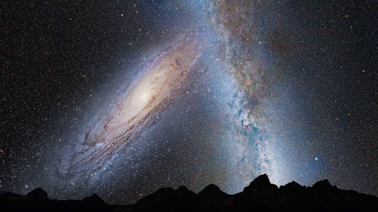 This illustration shows a stage in the predicted merger between our Milky Way galaxy and the neighboring Andromeda galaxy, as it will unfold over the next several billion years. In this image, representing Earth's night sky in 3.75 billion years, Andromeda (left) fills the field of view and begins to distort the Milky Way with tidal pull. (Credit: NASA; ESA; Z. Levay and R. van der Marel, STScI; T. Hallas; and A. Mellinger)