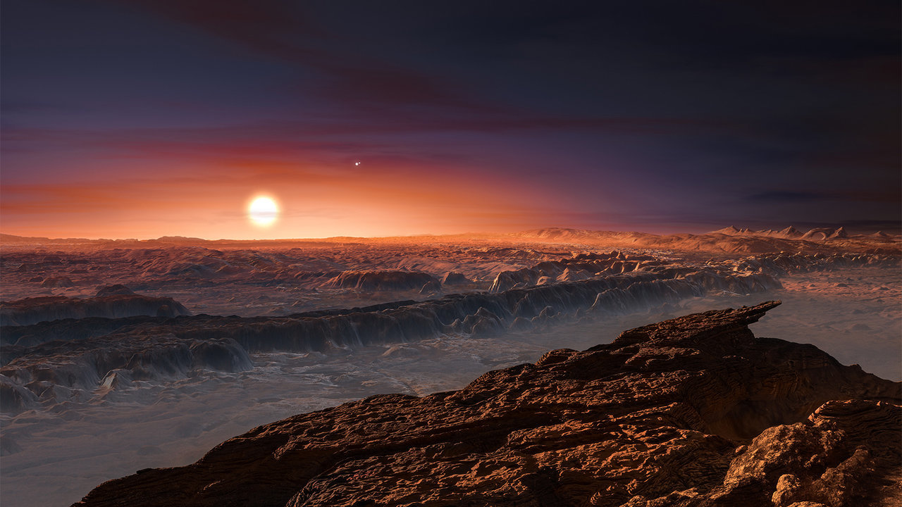 This artist’s impression shows a view of the surface of the planet Proxima b orbiting the red dwarf star Proxima Centauri, the closest star to the solar system. The double star Alpha Centauri AB also appears in the image. Proxima b is a little more massive than the Earth and orbits in the habitable zone around Proxima Centauri, where the temperature is suitable for liquid water to exist on its surface. – Image Credits: ESO/M. Kornmesser