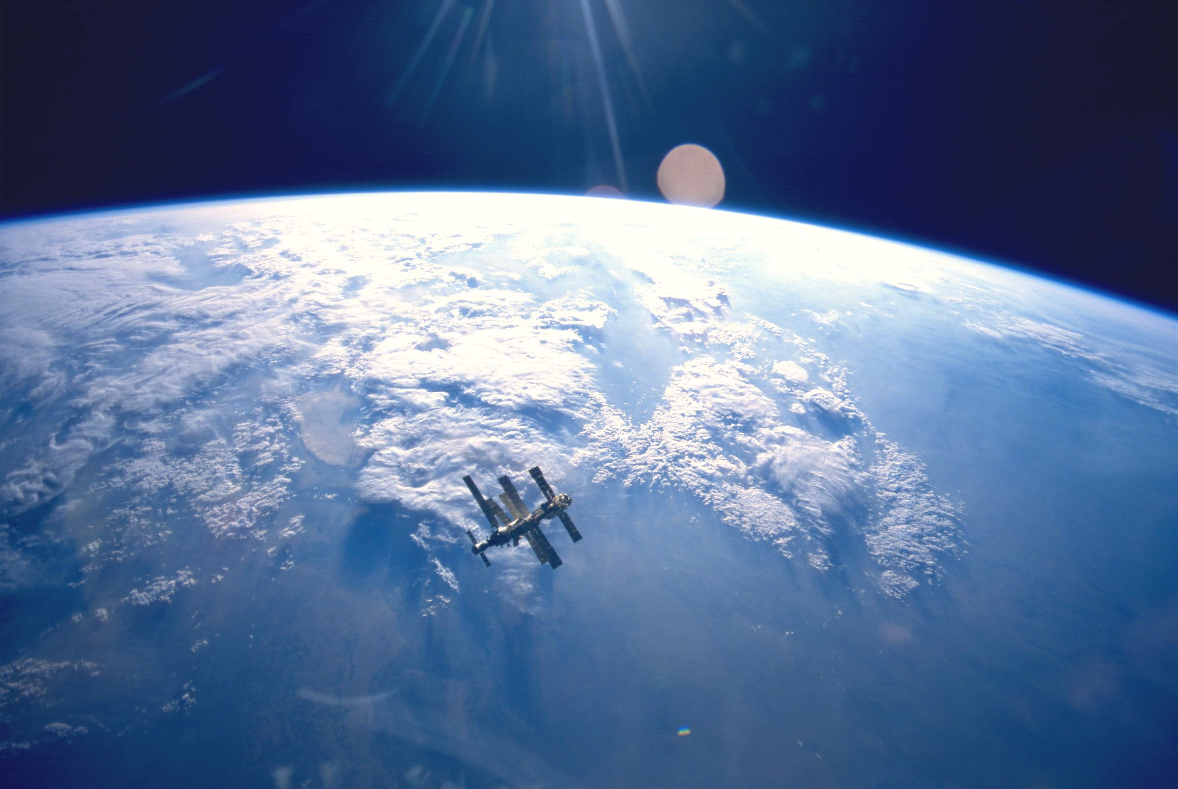 The Mir space station hangs above the Earth in 1995 (photo taken by the mission crew of the Space Shuttle Atlantis, STS-71) - Image Credit: NASA