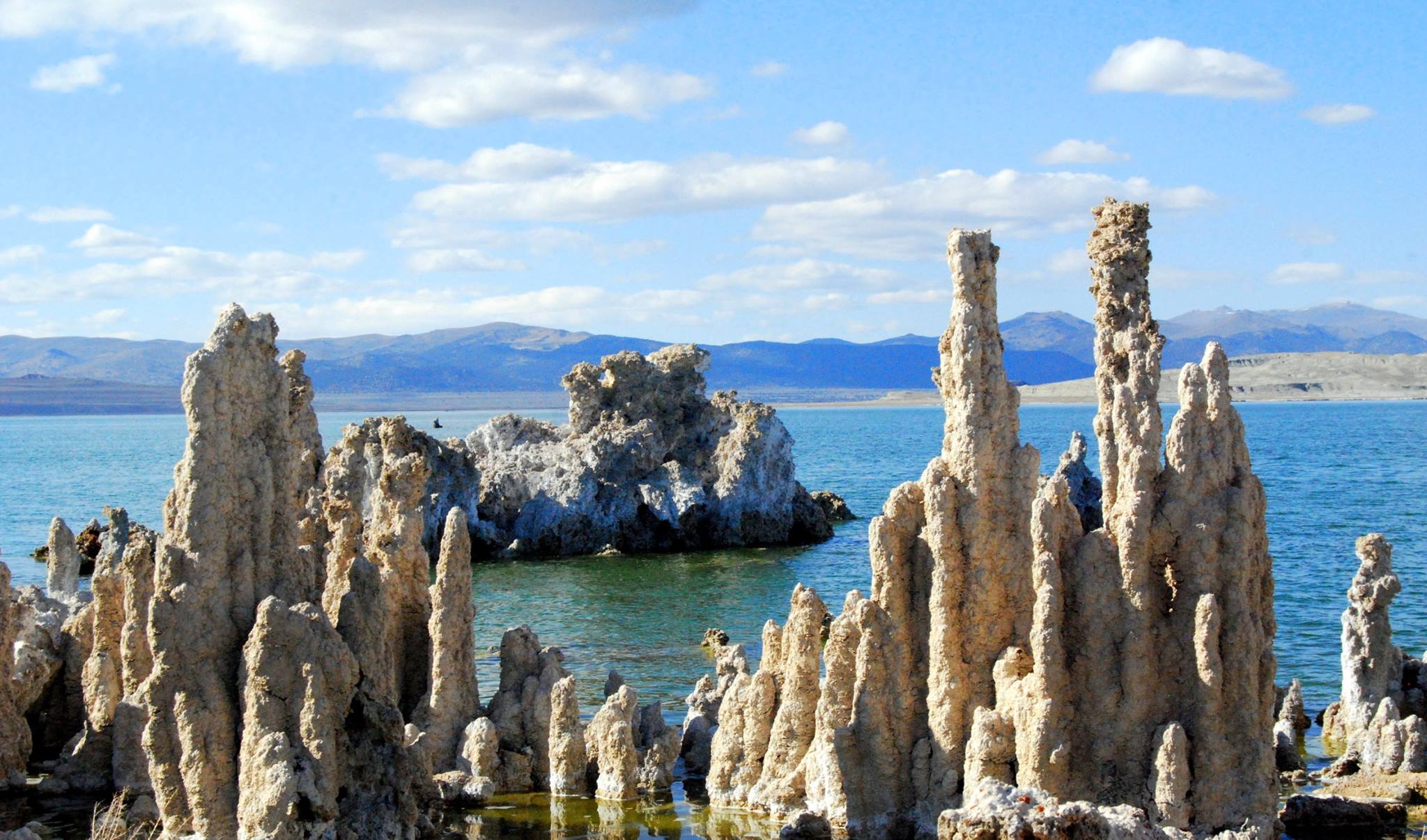 Mono Lake, California, with salt pillars known as "tufas" visible. JPL scientists tested new methods for detecting chemical signatures of life in the salty waters here, believing them to be analogs for water on Mars or ocean worlds like Europa. – Image Credits: Mono County Tourism