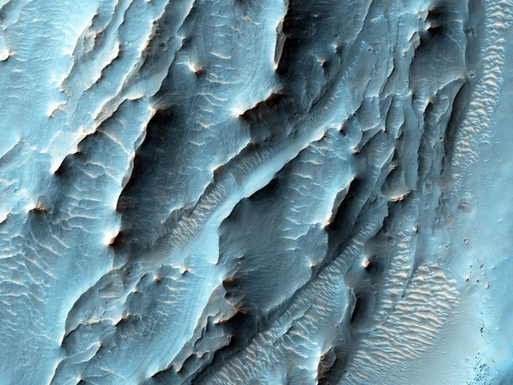 HiRise captured this image of unusual textures on the floor of the Gale Crater, the same crater where the Curiosity rover is working. - Image Credit: NASA/JPL-Caltech/Univ. of Arizona