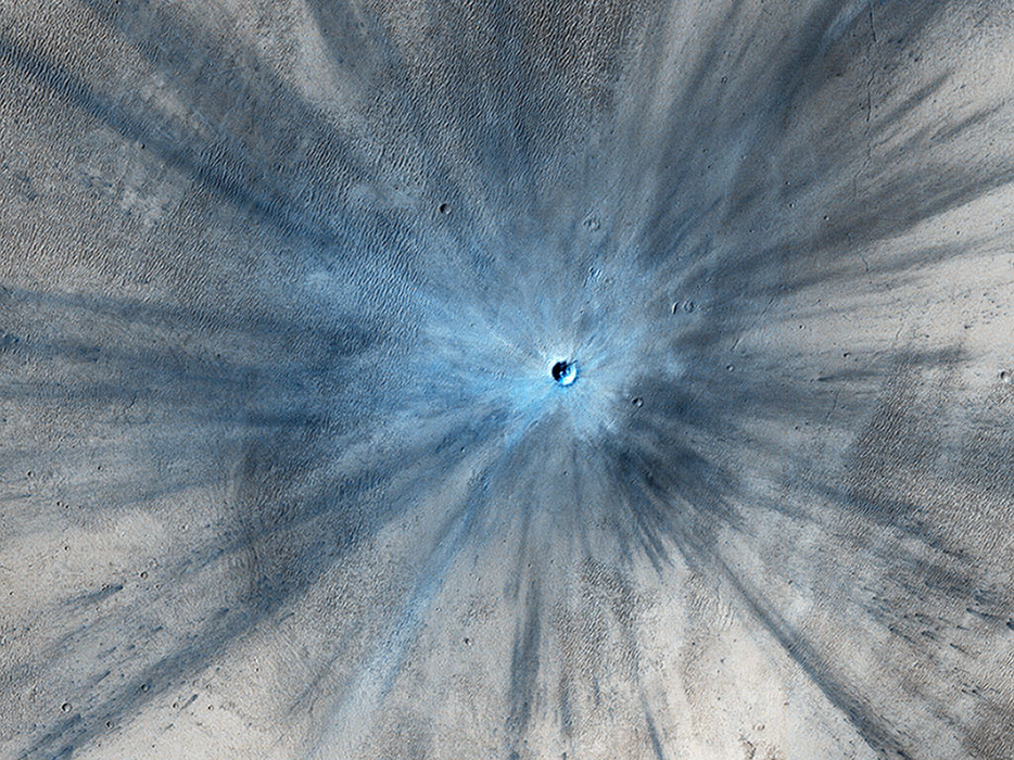 This color-enhanced image of a fresh Martian crater was captured by the HiRise camera. - Image Credit: NASA/JPL-Caltech/Univ. of Arizona