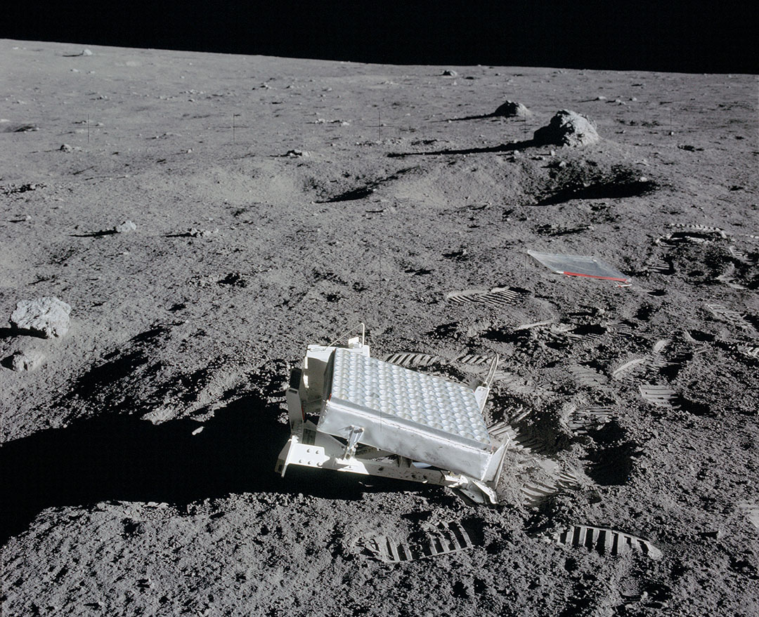 The Lunar Laser Ranging Experiment placed on the Moon by the Apollo 14 astronauts. Observatories beam a laser to the small array, which reflects a bit of the light back. Measuring the time delay yields the Moon’s distance to within about a millimeter. At the Moon’s surface the laser beam spreads out to 4 miles wide and only one photon is reflected back to the telescope every few seconds. - Image Credit: NASA