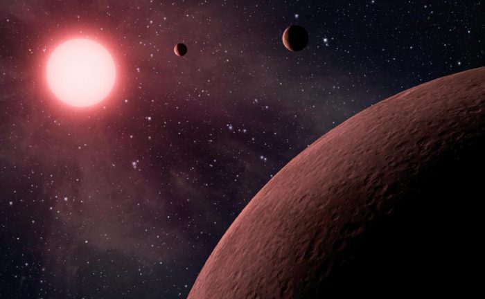 Artist's impression of a system of exoplanets orbiting a low mass, red dwarf star. - Image Credit: NASA/JPL