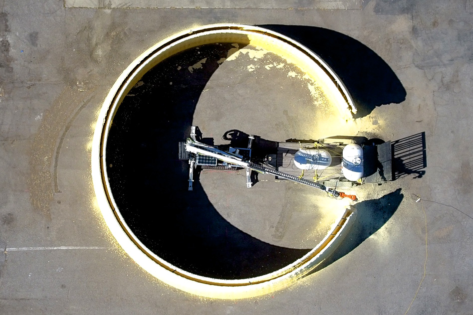 MIT researchers have designed a system that can 3-D print the basic structure of an entire building. The system consists of a tracked vehicle that carries a large industrial robotic arm, which has a smaller, precision-motion robotic arm at its end. - Image Credit: Steven Keating, Julian Leland, Levi Cai, and Neri Oxman/Mediated Matter Group