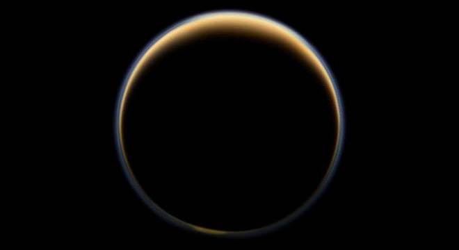 ASA’s Cassini spacecraft looks toward the night side of Saturn’s largest moon and sees sunlight scattering through the periphery of Titan’s atmosphere and forming a ring of color. - Image Credit: NASA/JPL-Caltech/Space Science Institute