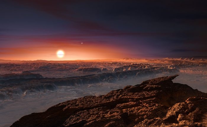 Artist’s impression of the surface of the planet Proxima b orbiting the red dwarf star Proxima Centauri. The double star Alpha Centauri AB is visible to the upper right of Proxima itself. - Image Credit: ESO