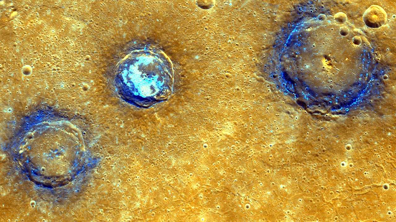 Enhanced-color image of Munch, Sander and Poe craters amid volcanic plains (orange) near Caloris Basin. - Image Credit: NASA/JHUAPL/Carnegie Institution of Washington