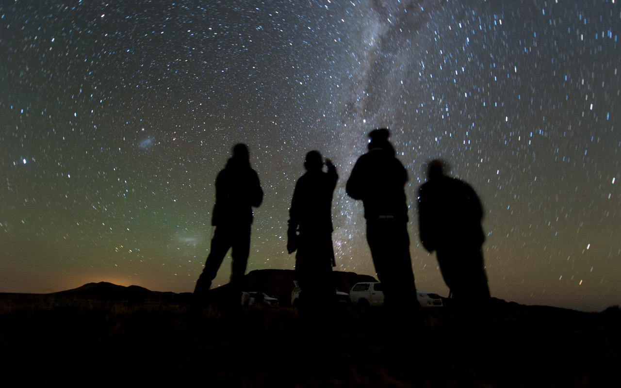 Four members of the New Horizons’ South African observation team scan the sky while waiting for the start of the 2014 MU69 occultation, early on the morning of June 3, 2017. - Image Credits: NASA/JHUAPL/SwRI/Henry Throop
