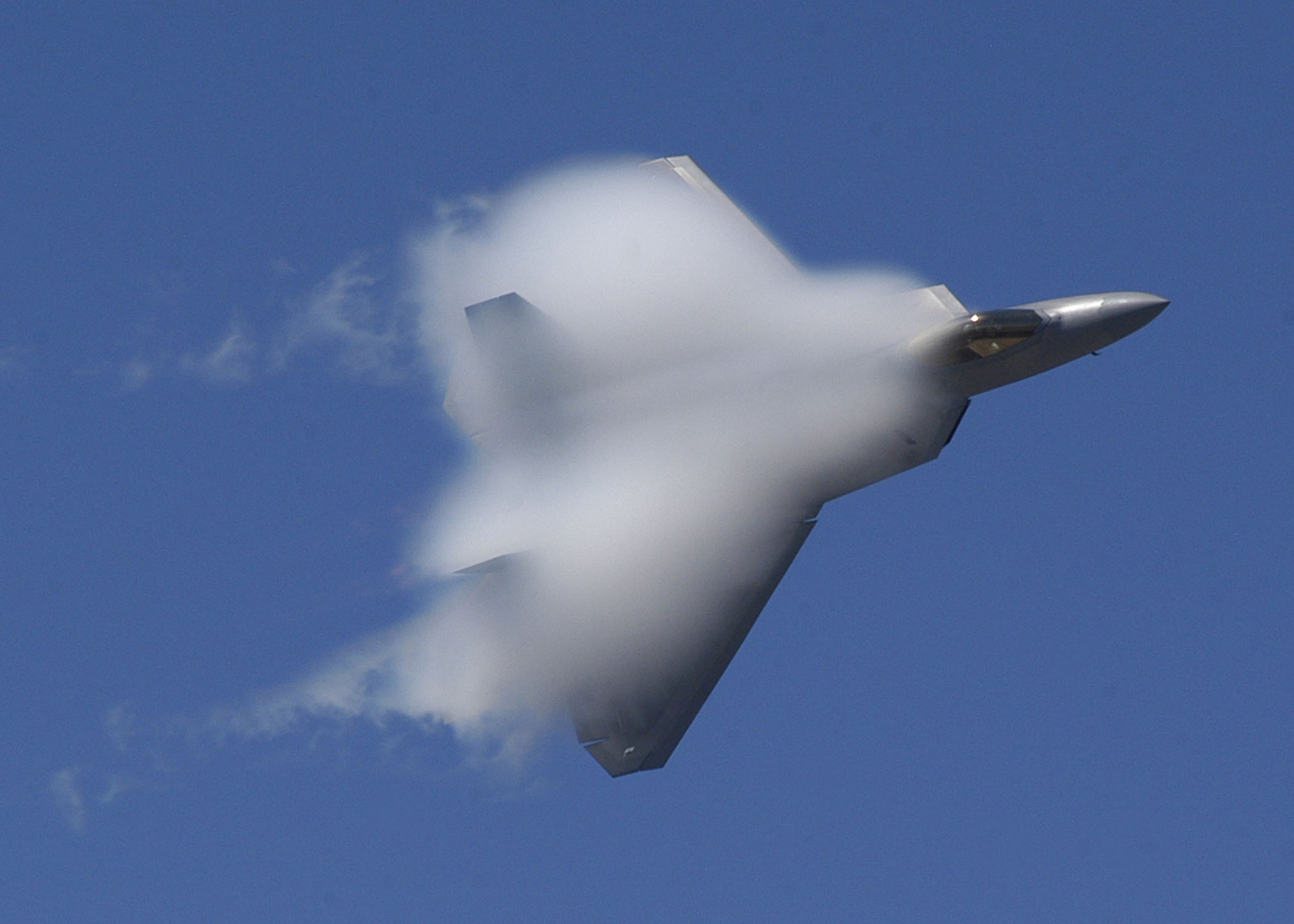 An F-22 Raptor reaching a velocity high enough to achieve a sonic boom. - Image Credit: Jason R. Williams/WikimediaCommons