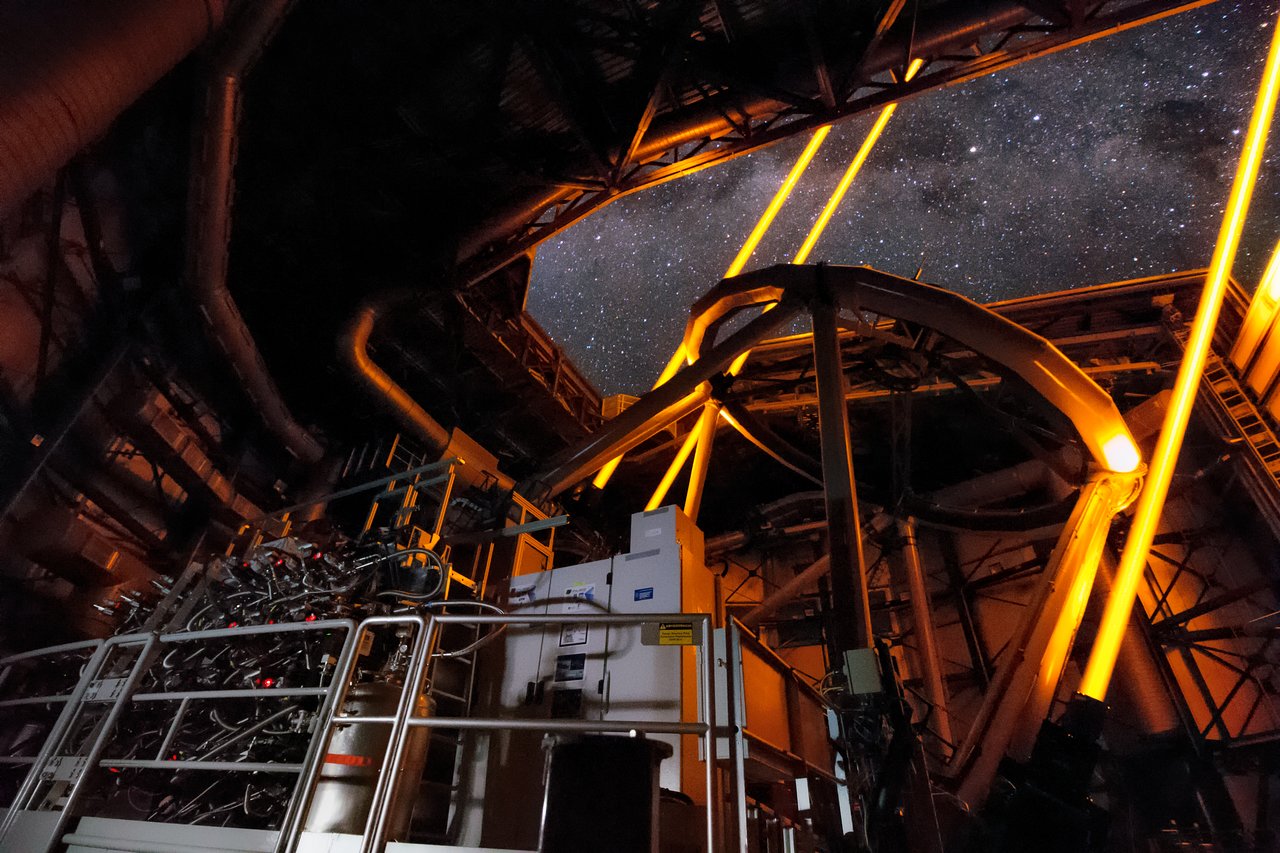 Inside the UT4 of the Very Large Telescope, part of the Adaptive Optics Facility, the four Laser Guide Stars Facility, point to the skies during the first observations using the MUSE instrument. The sharpness and dynamic range of images using the AOF equipped MUSE instrument will dramatically improve future observations. - Image Credit: Roland Bacon