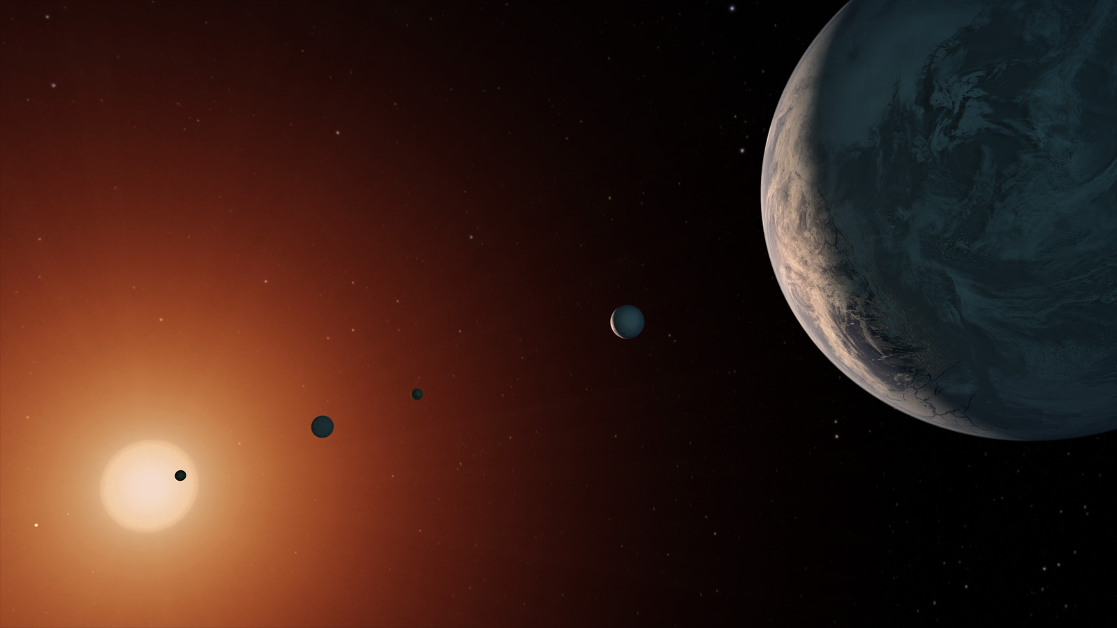 This illustration shows what the TRAPPIST-1 system might look like from a vantage point near planet TRAPPIST-1f (at right). - Image Credits: NASA/JPL-Caltech