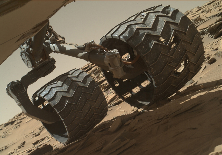 Image taken by the Mars Hand Lens Imager (MAHLI) camera showing the condition of Curiosity’s left-middle and left-rear wheels. - Image Credit: NASA/JPL-Caltech/MSSS